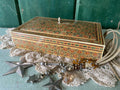 Decorative box with intricate red and green geometric patterns