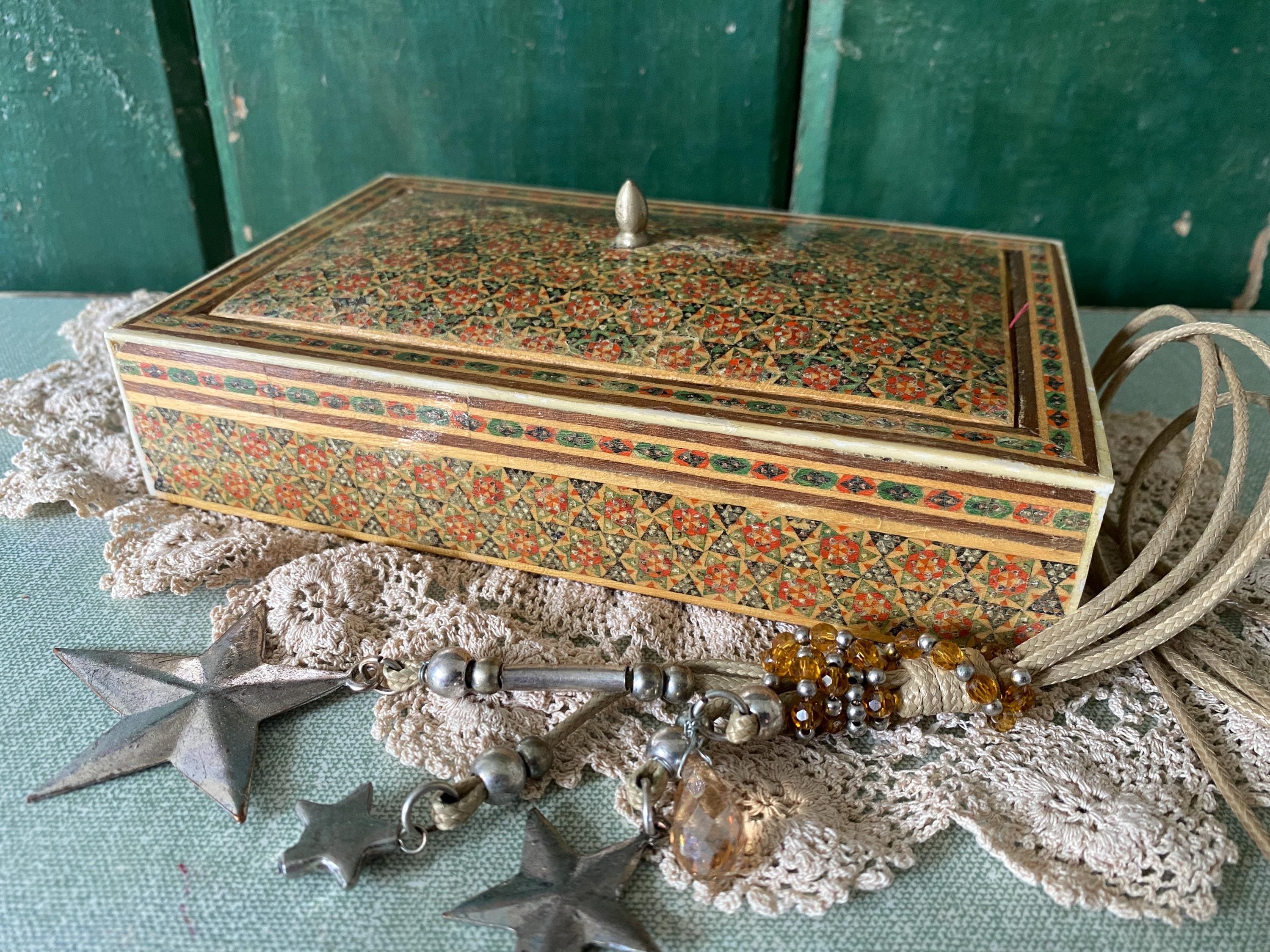 Decorative box with intricate red and green geometric patterns