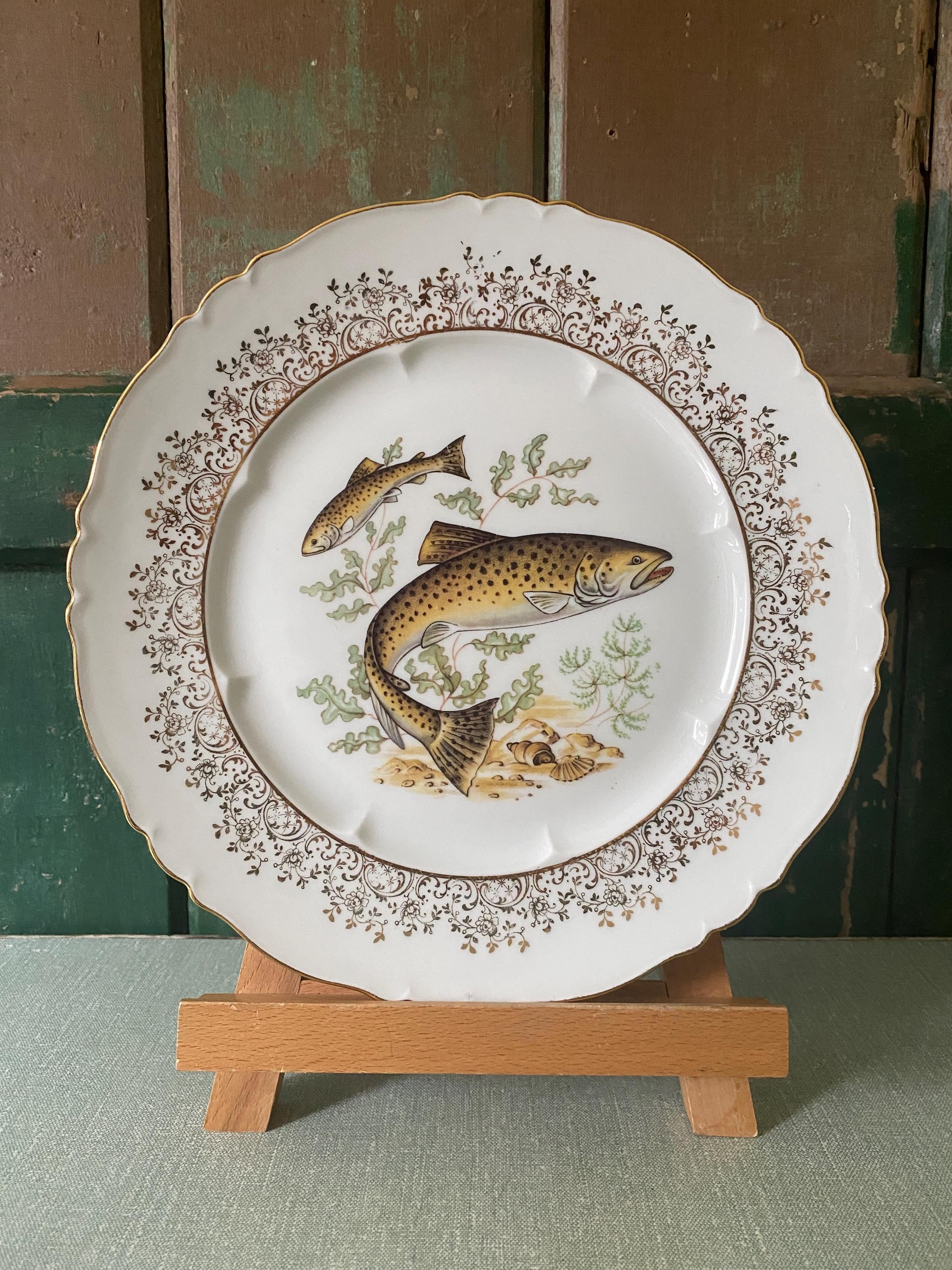 Set of three decorative plates with fish illustrations 
