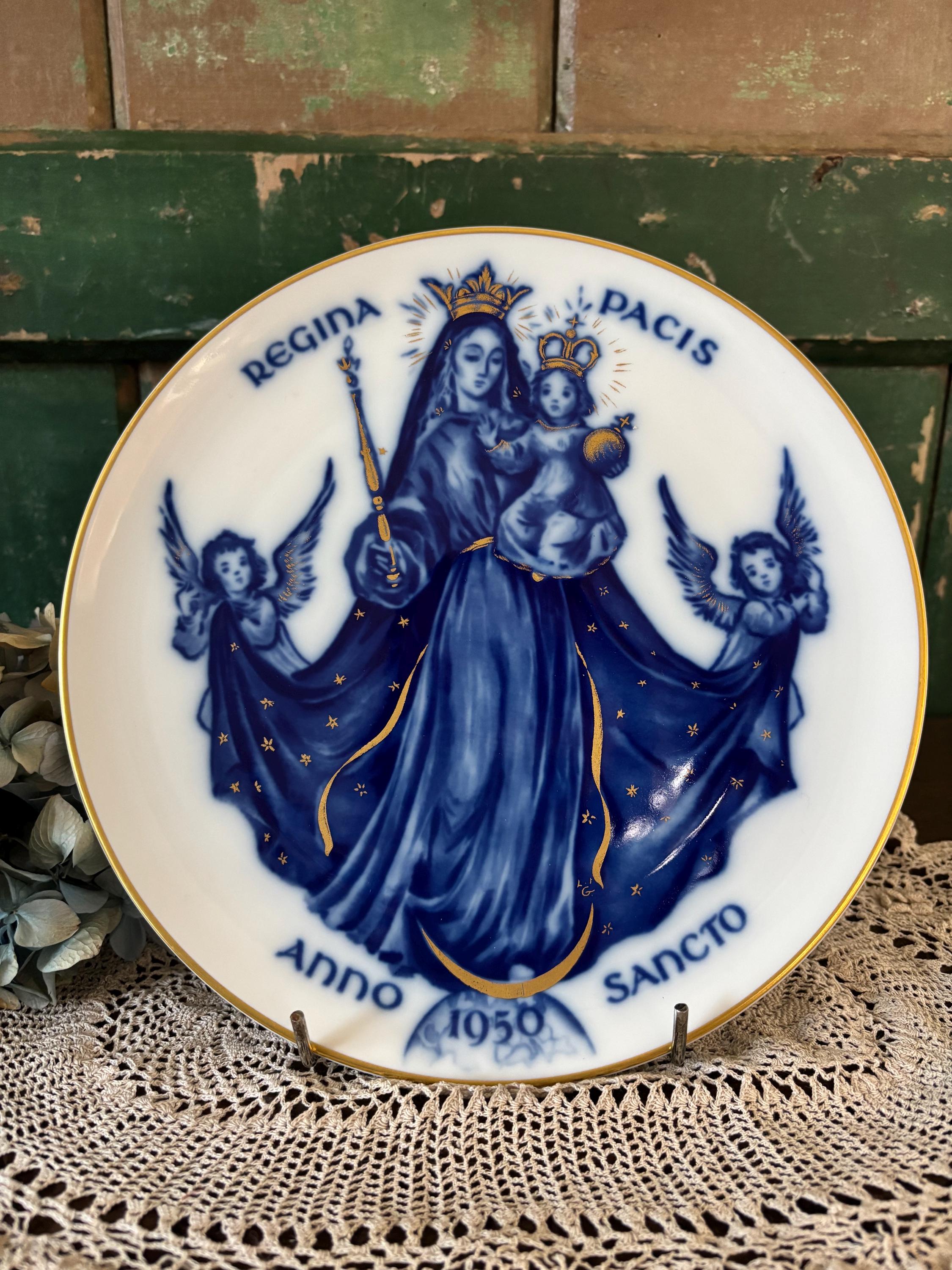 Decorative plate with blue and gold religious design featuring Mary and angels