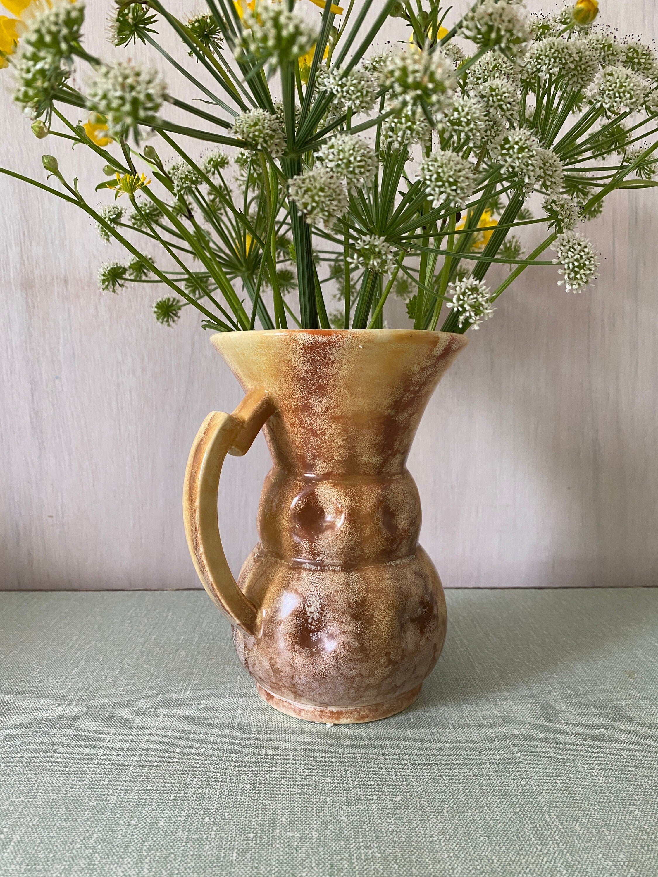 Brown ceramic jug with mottled glaze