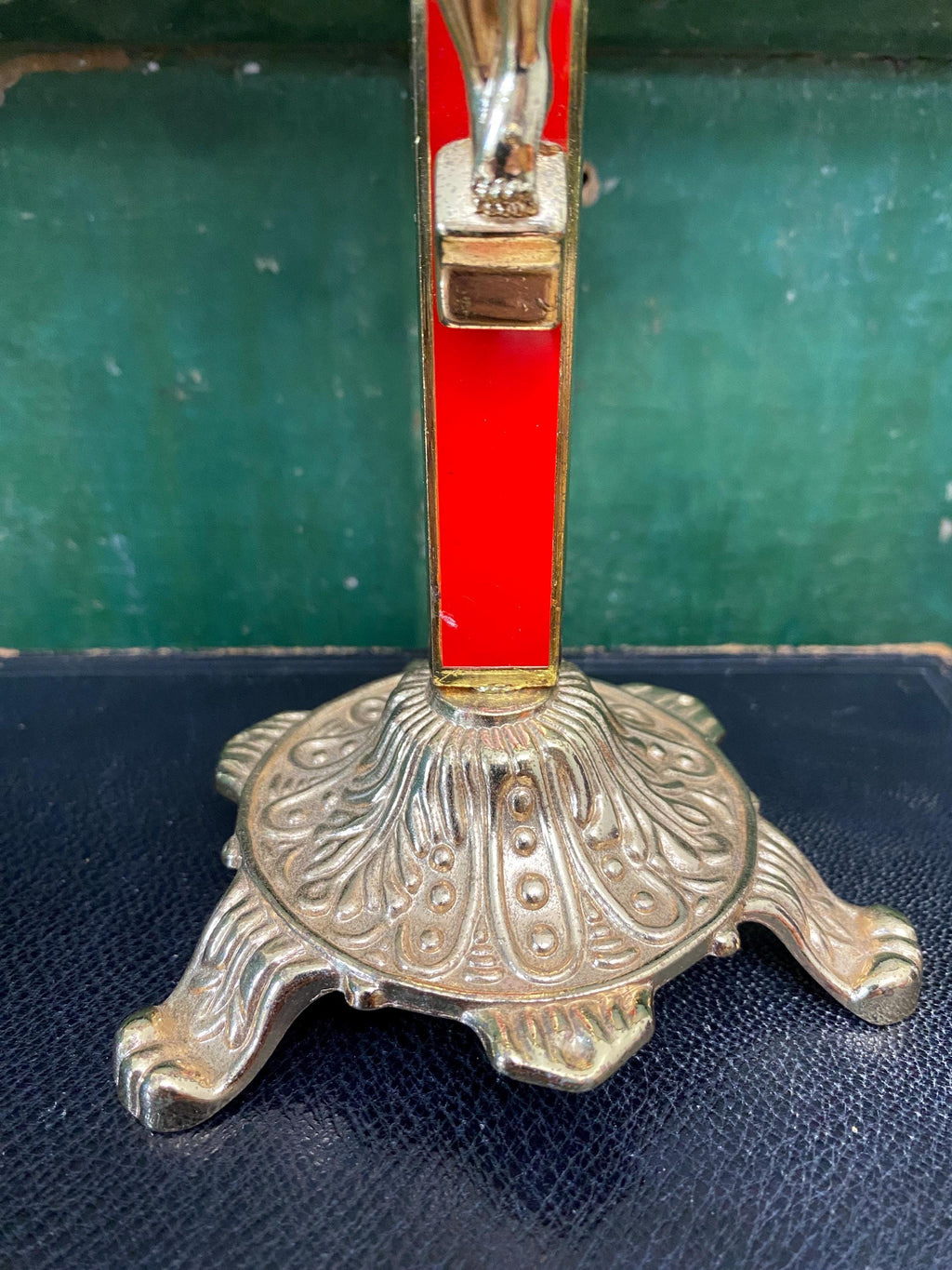 Decorative base of a gold and red crucifix