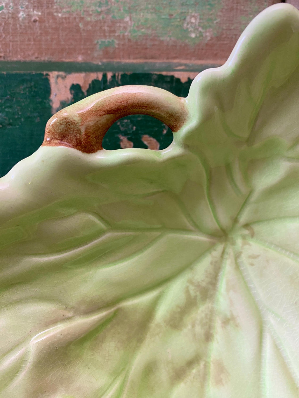 Close-up of a green ceramic leaf-shaped dish