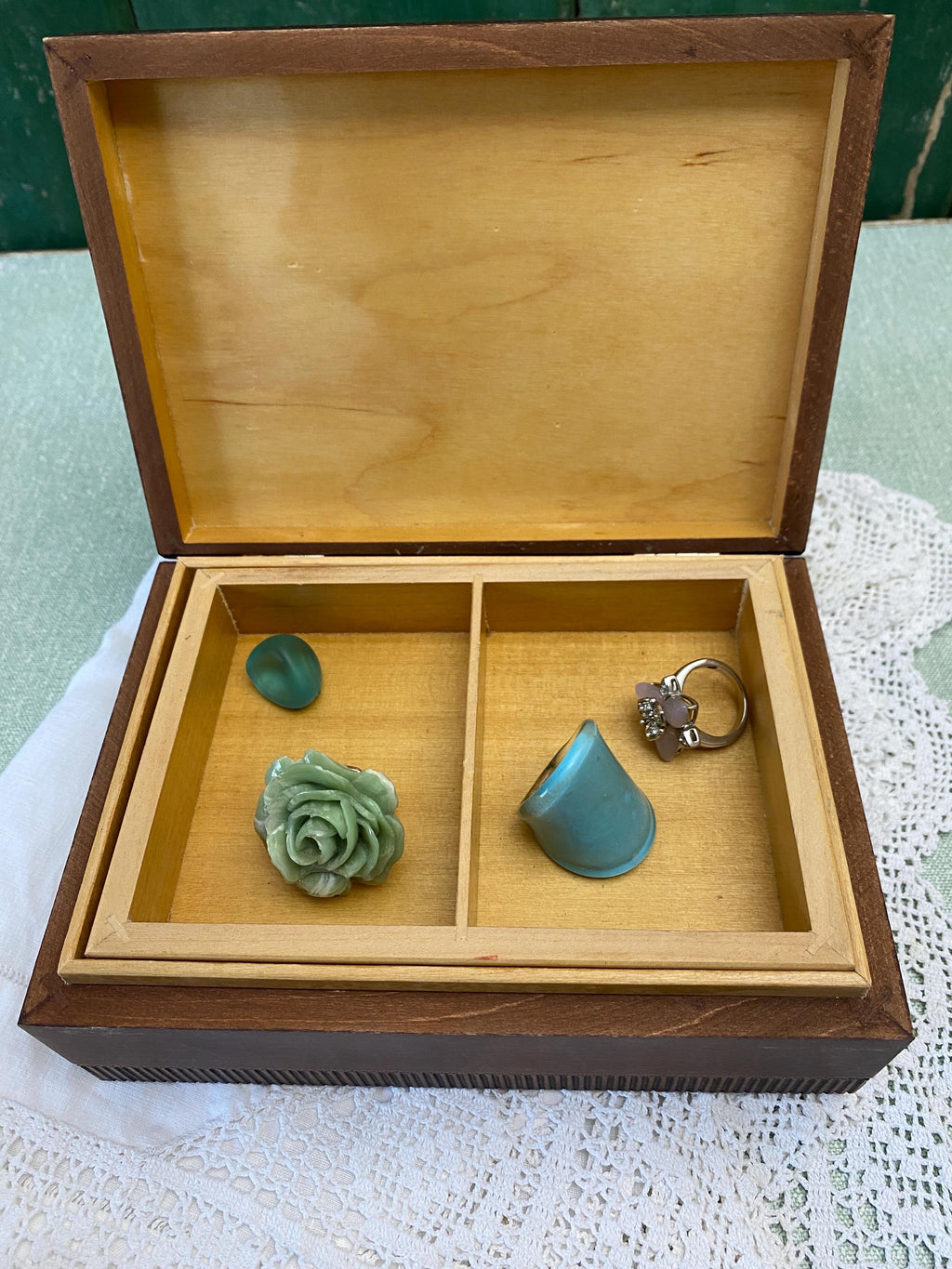 Wooden jewelry box with some jewelry items