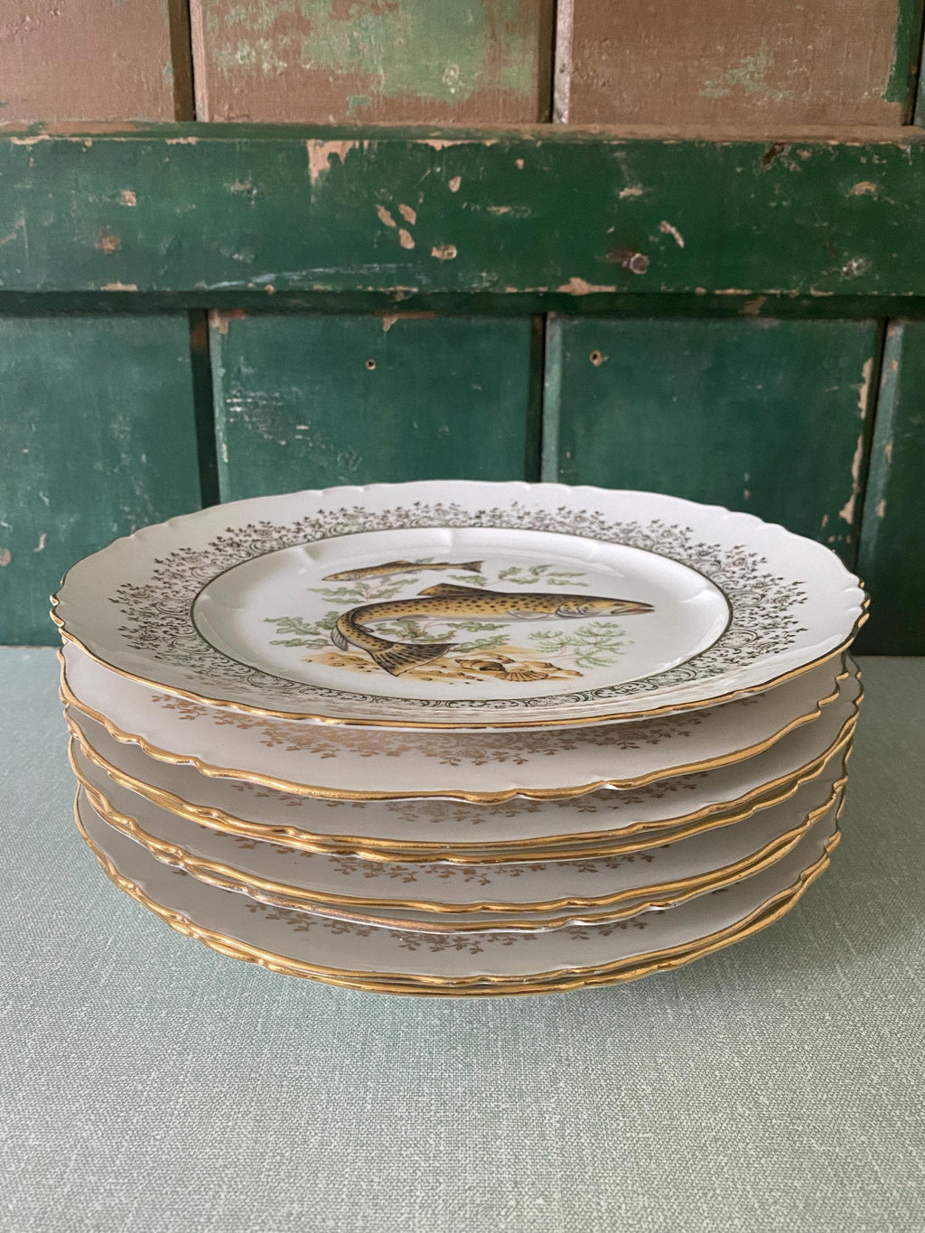 Stack of decorative plates with fish design 