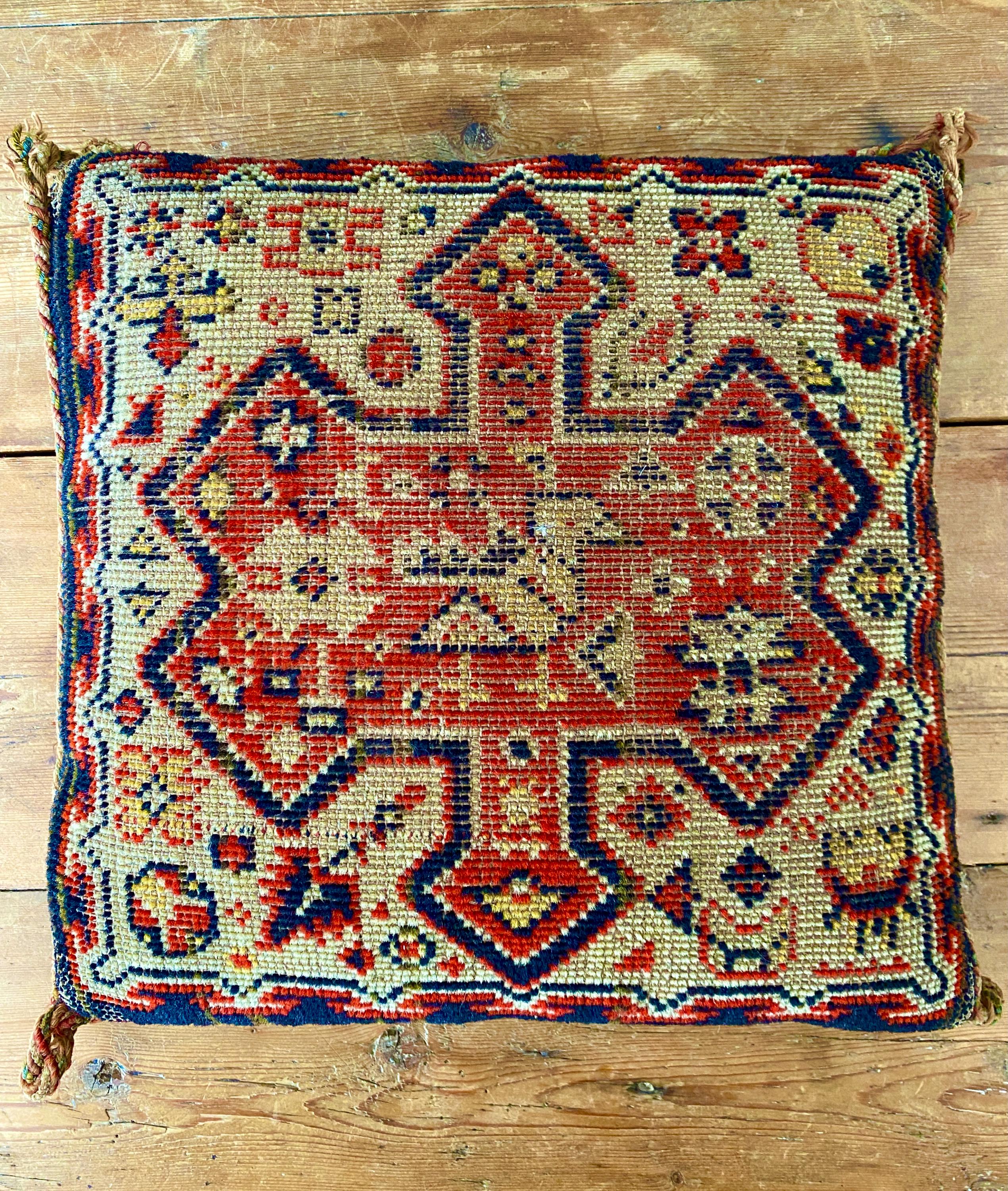 Woven cushion with blue and red geometric pattern
