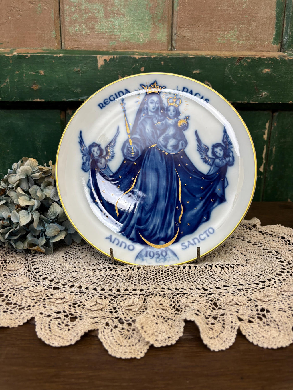 Decorative plate with blue and gold religious design featuring Mary and angels