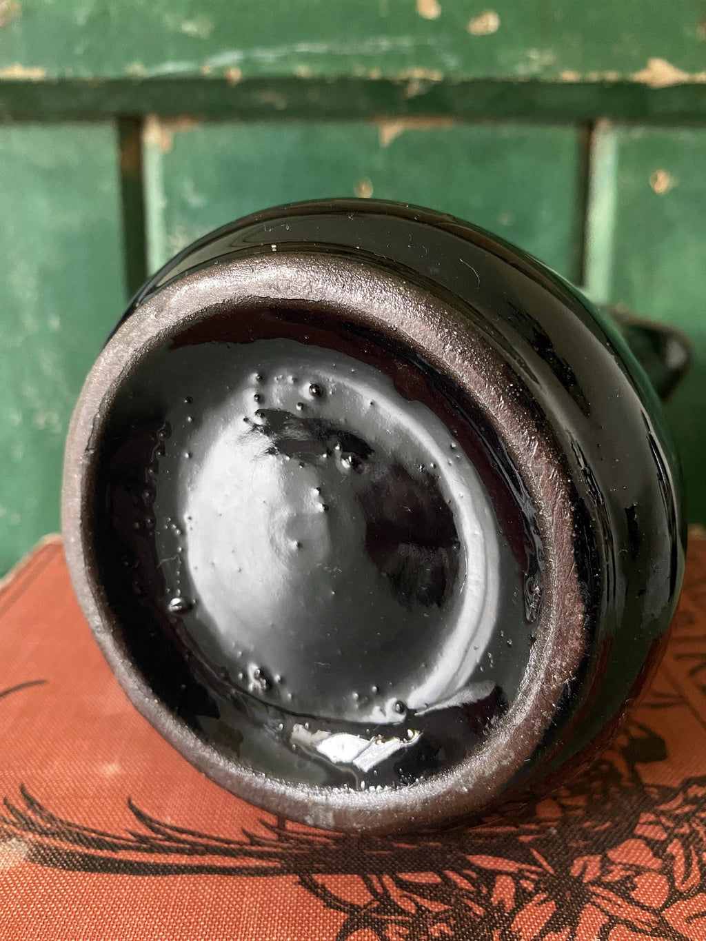 Close-up of the base of a black ceramic jug