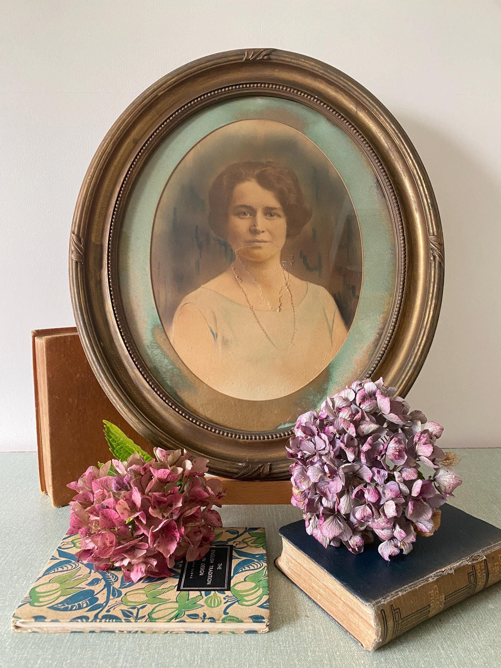 Vintage portrait of a woman in an oval gold frame