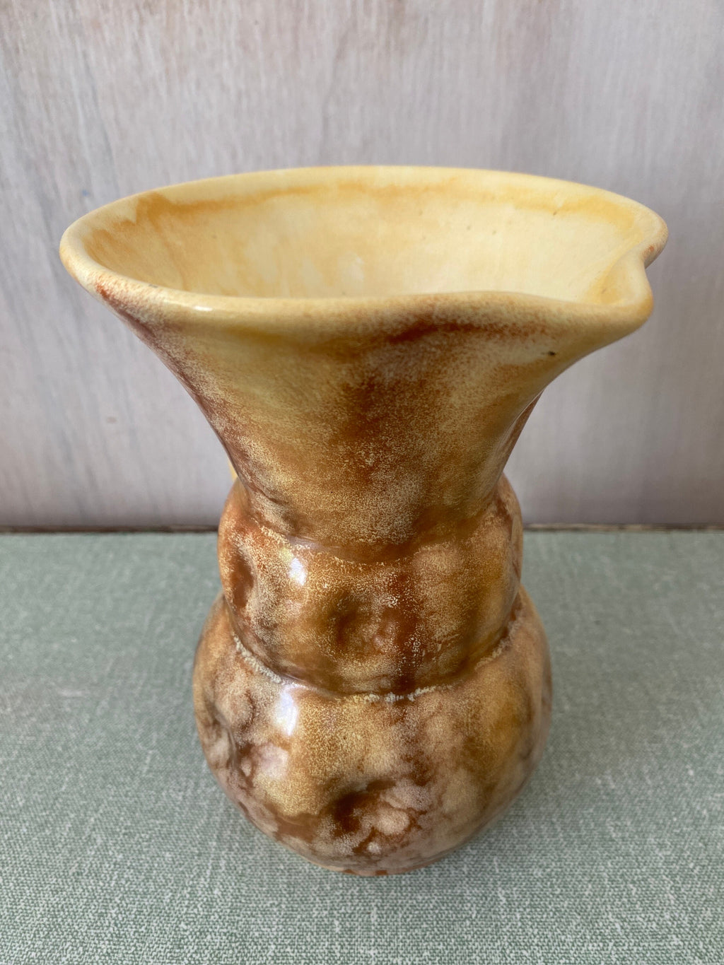 Top view of brown ceramic jug with cream interior and mottled glaze