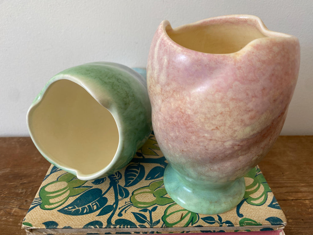Close-up of two ceramic vases, one showing a view of the inside