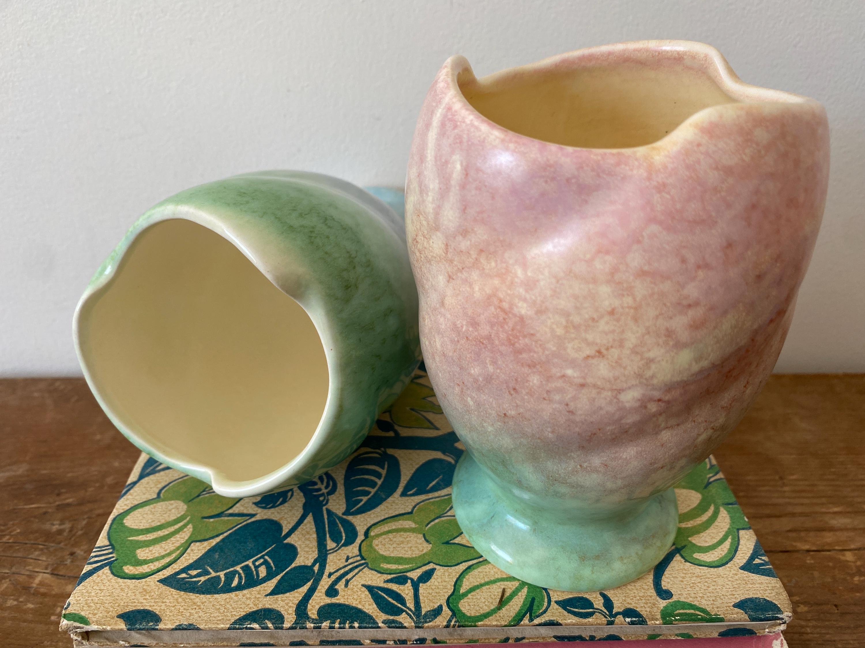 Close-up of two ceramic vases, one showing a view of the inside