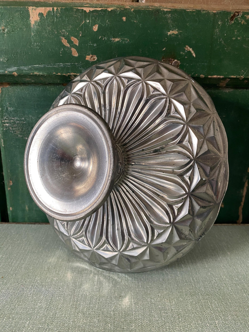 underside of a decorative mercury glass cake stand