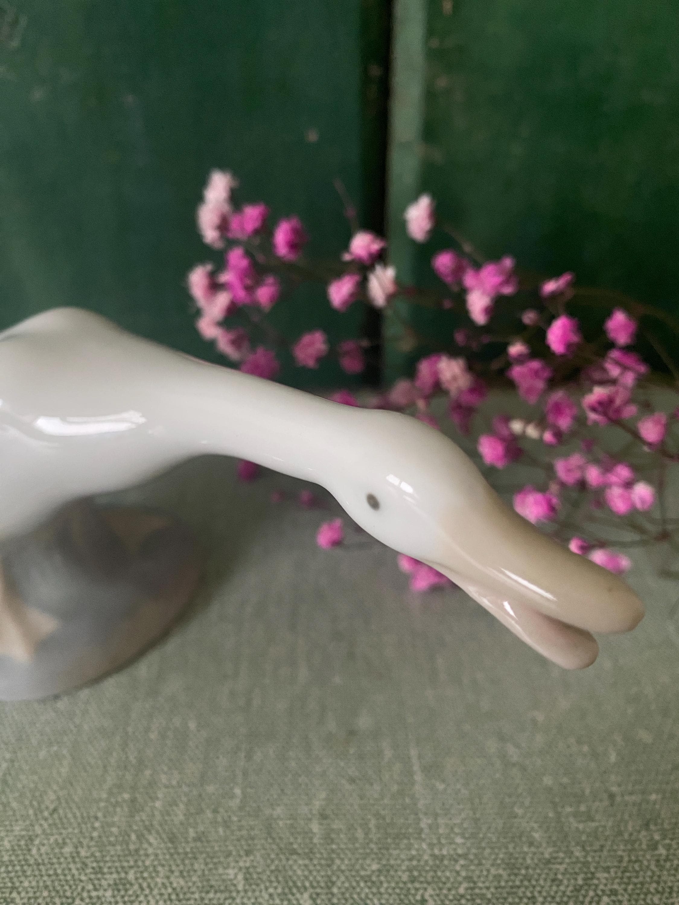 Close-up of a white ceramic goose figurine 