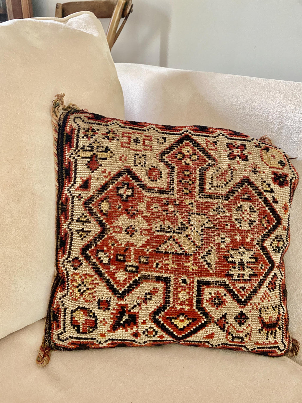 Decorative cushion with intricate woven patterns