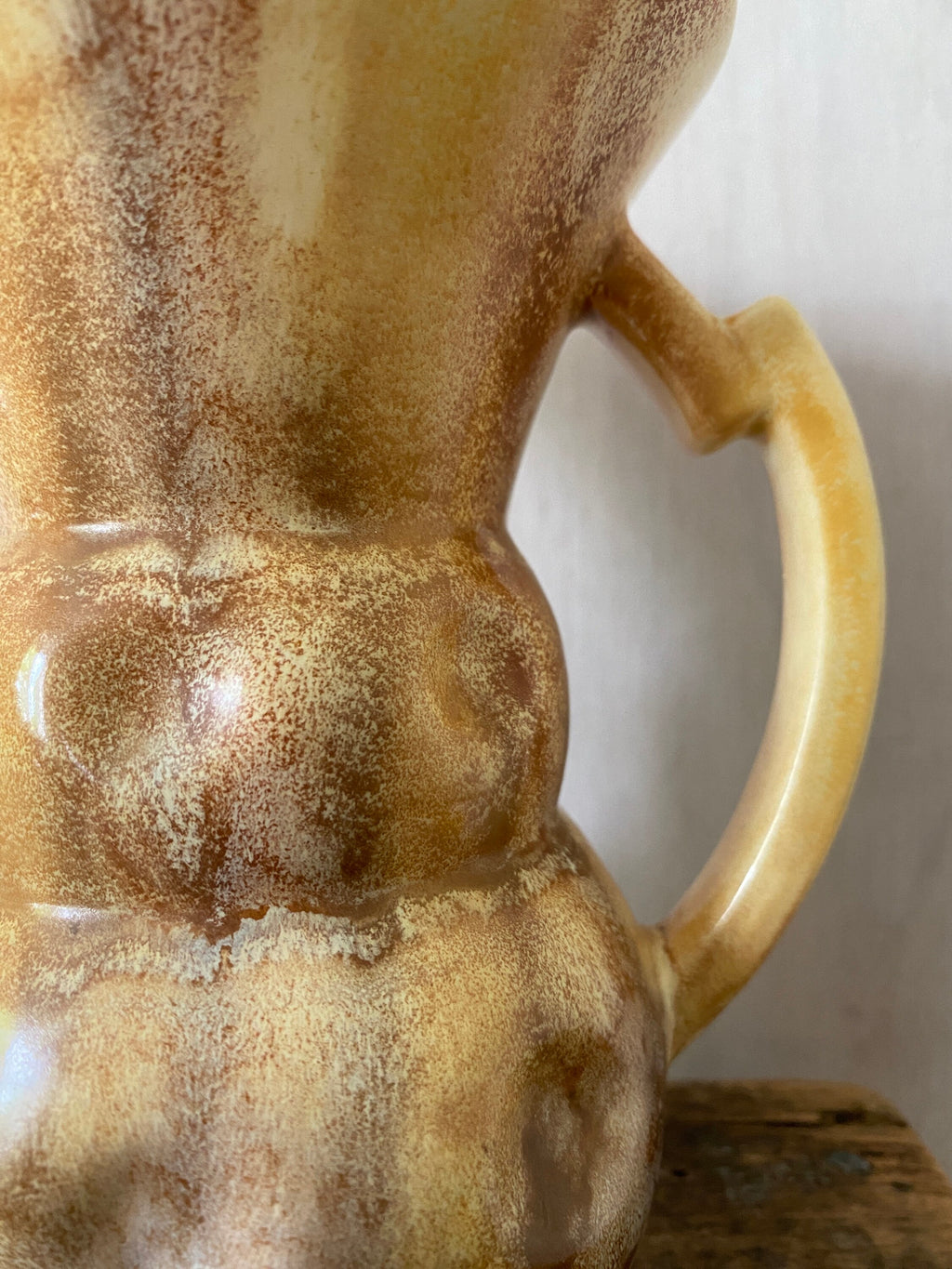 Cose-up of brown ceramic jug with mottled glaze