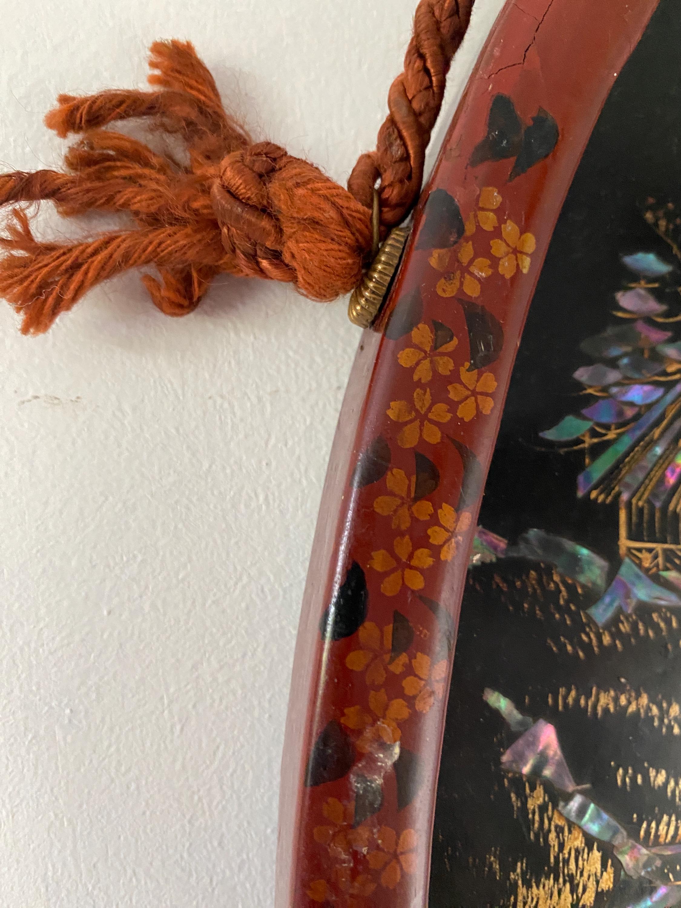 Close up detail part of a hand decorated wooden frame with orange braid 