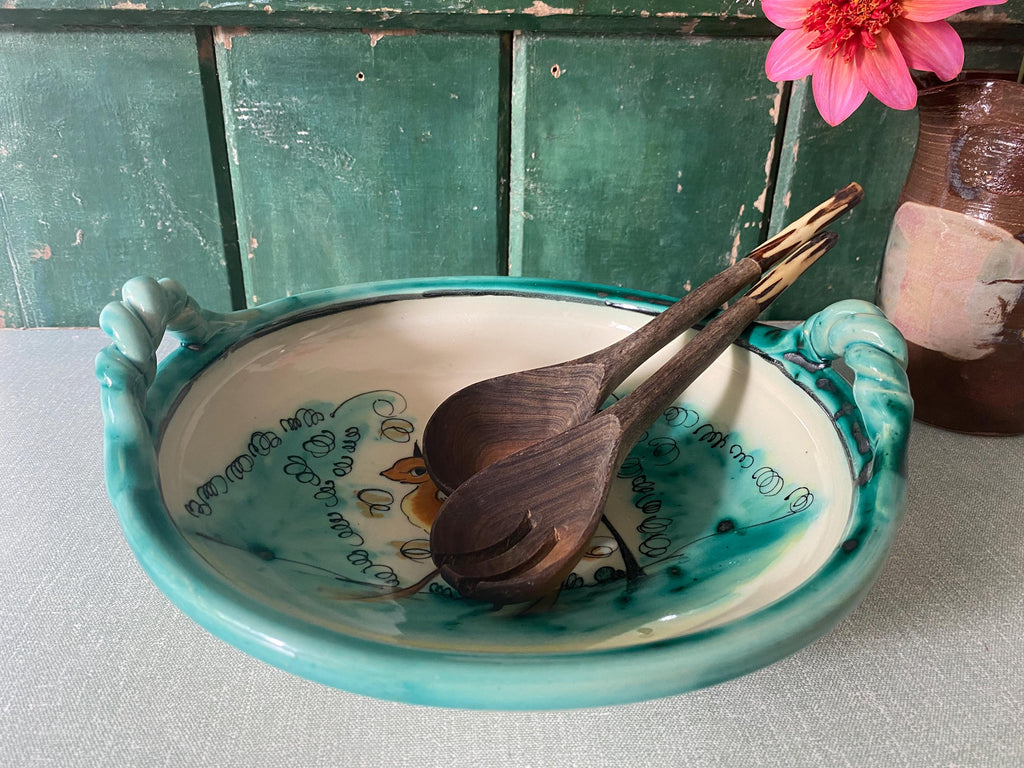 Green ceramic bowl with decorative handles