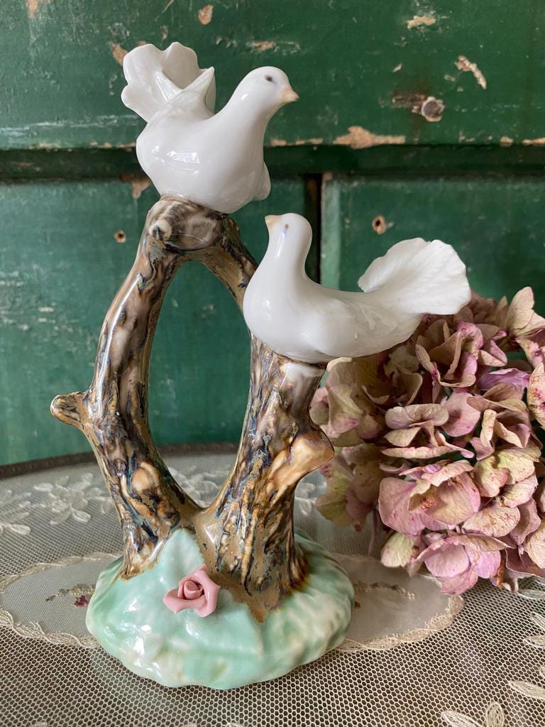 Decorative figurine of two white doves on a branch