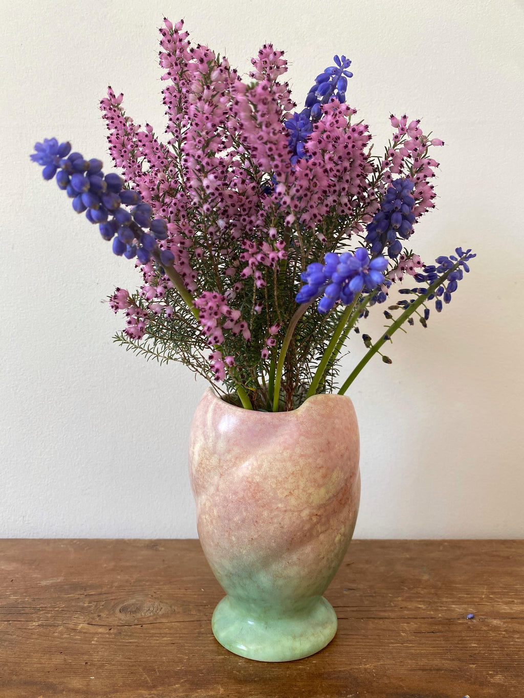 A pink and green ceramic vase