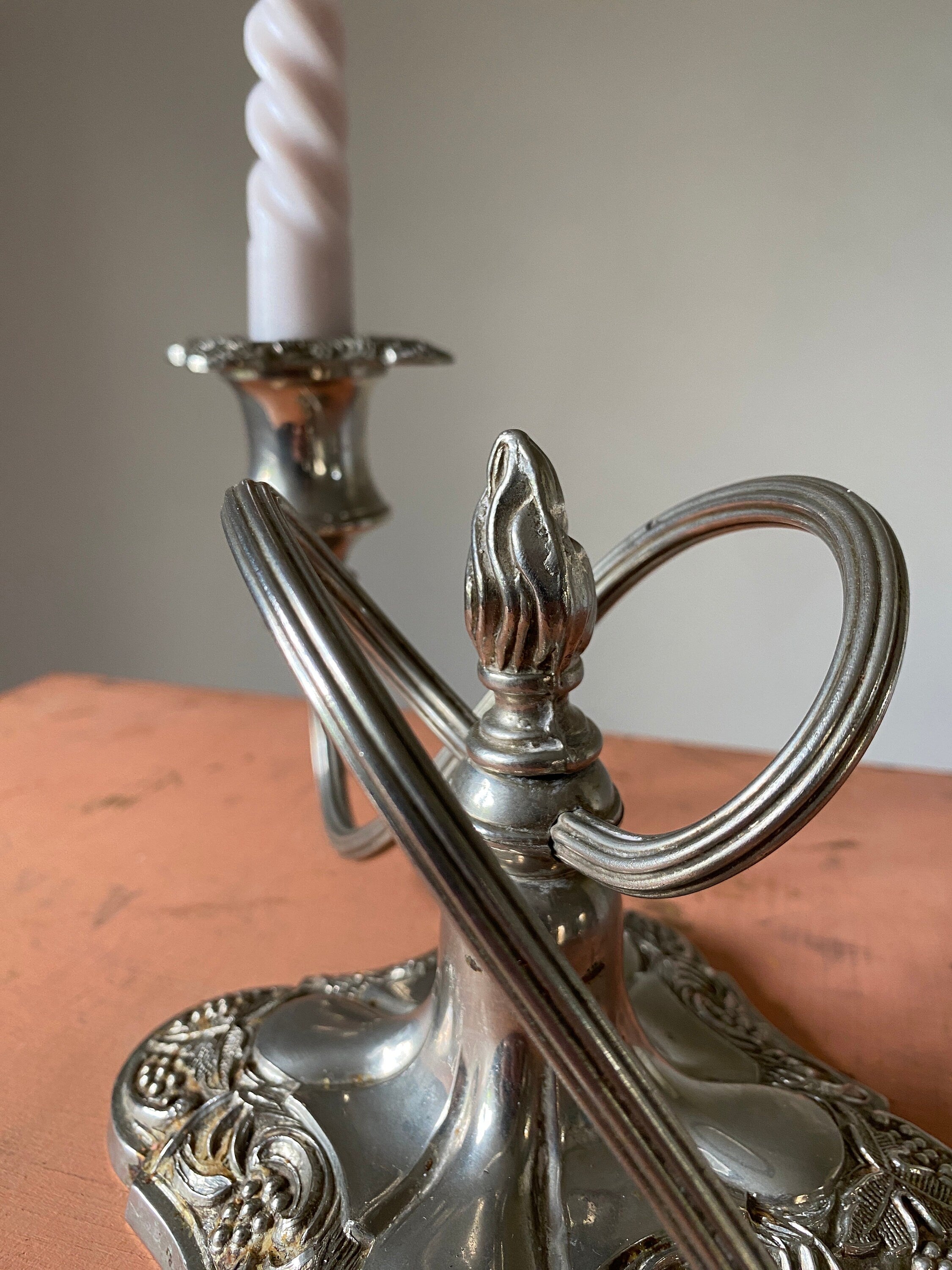 Close-up of a silver candle holder showing decorative detail