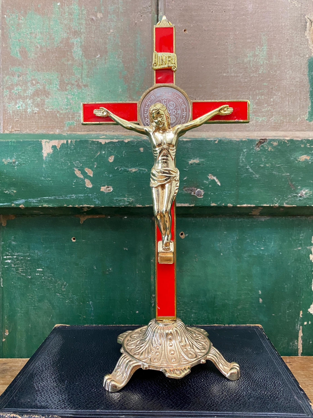 Gold and red decorative crucifix on a stand