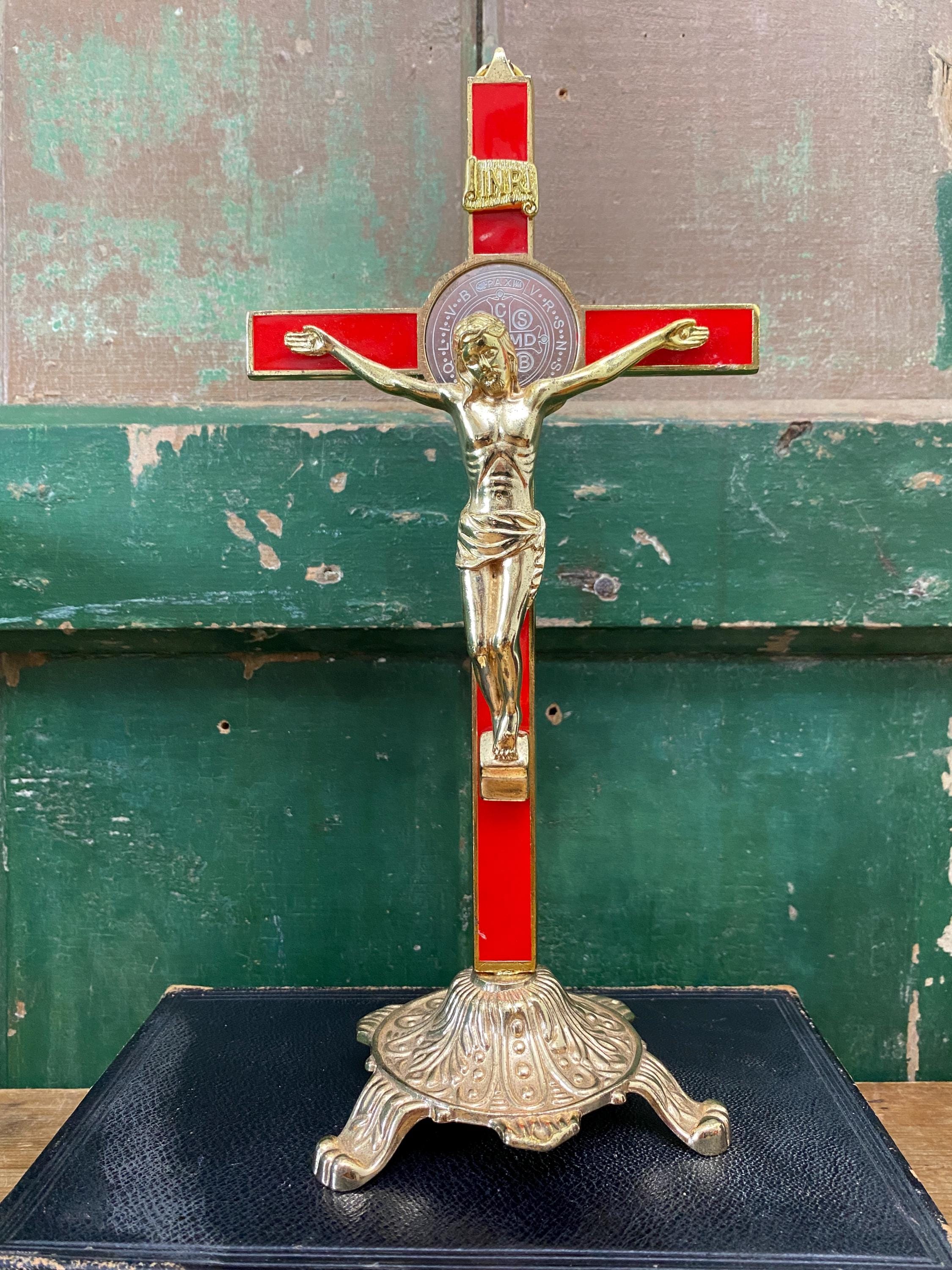 Gold and red decorative crucifix on a stand