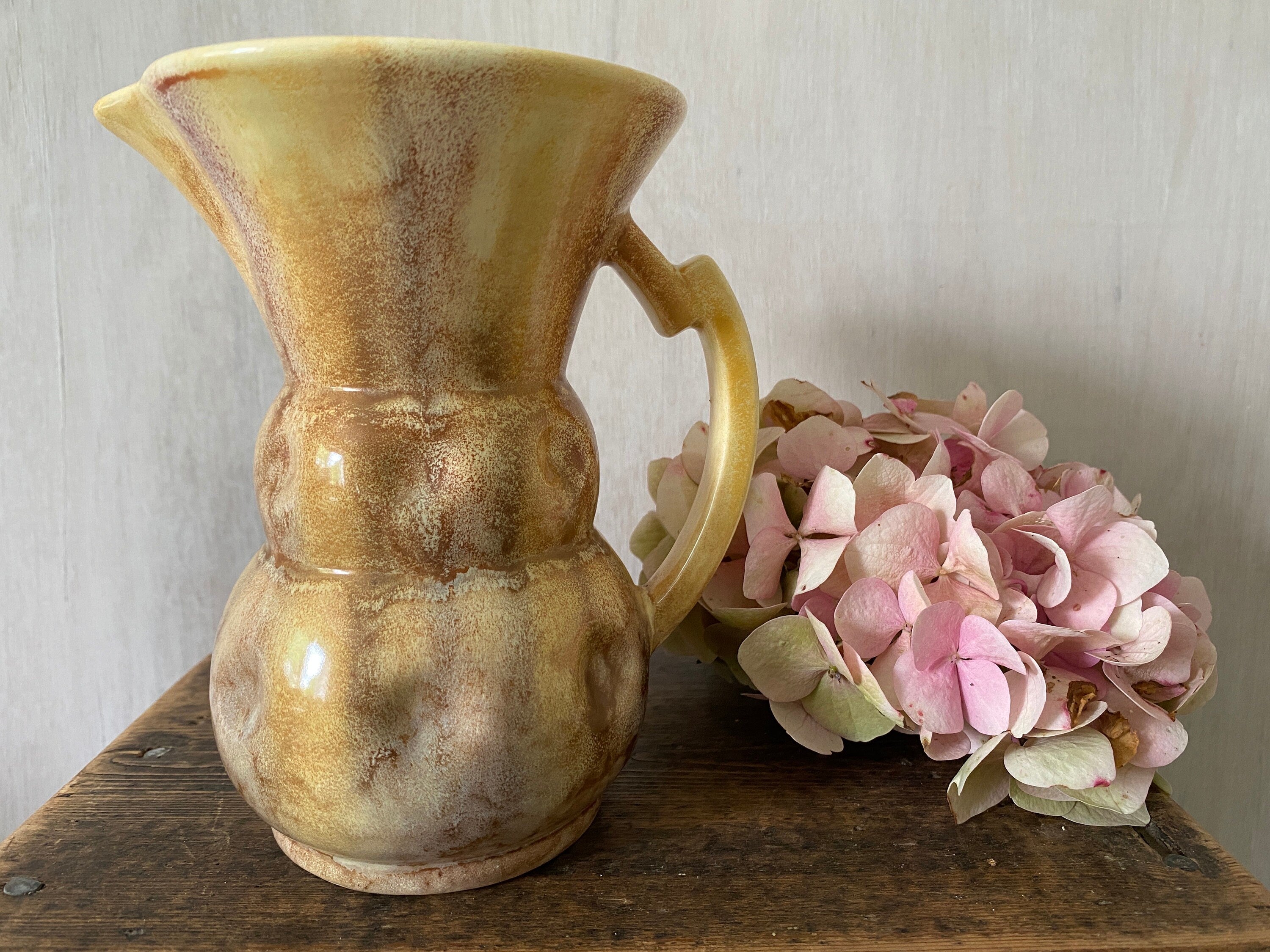 Brown ceramic jug with mottled glaze
