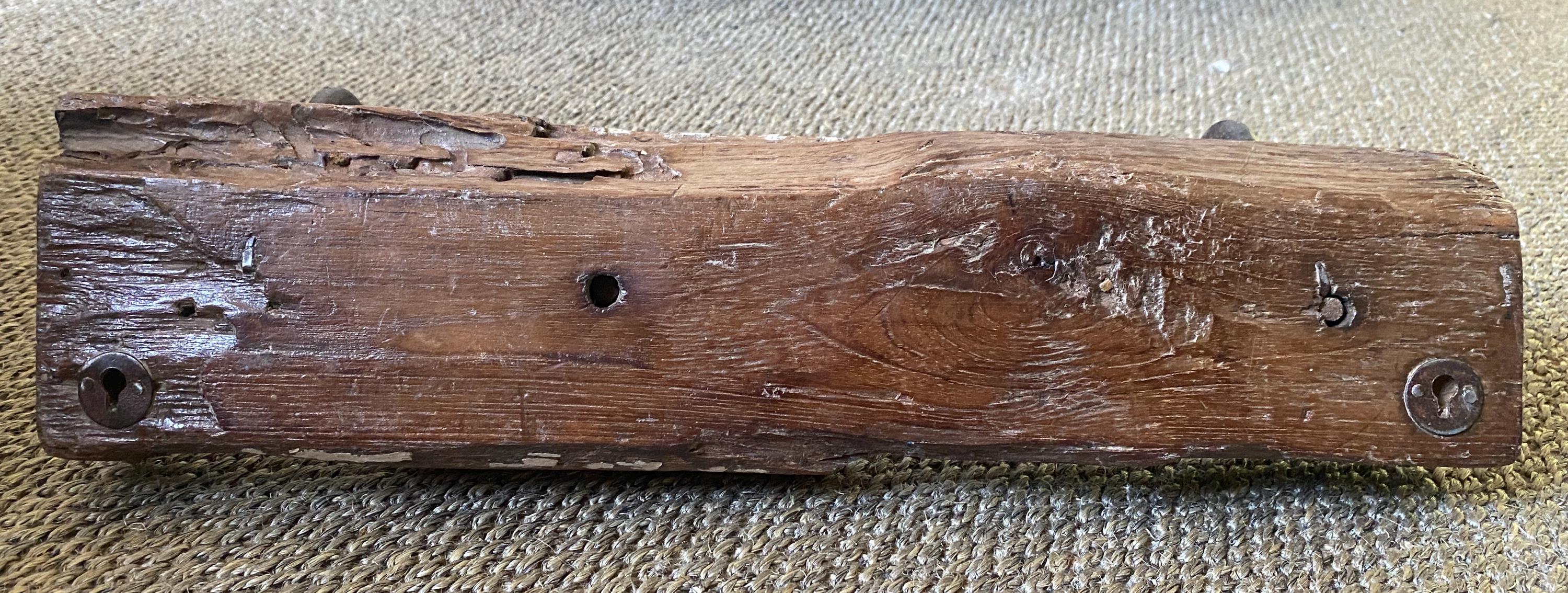 Worn wooden block with metal fasteners 