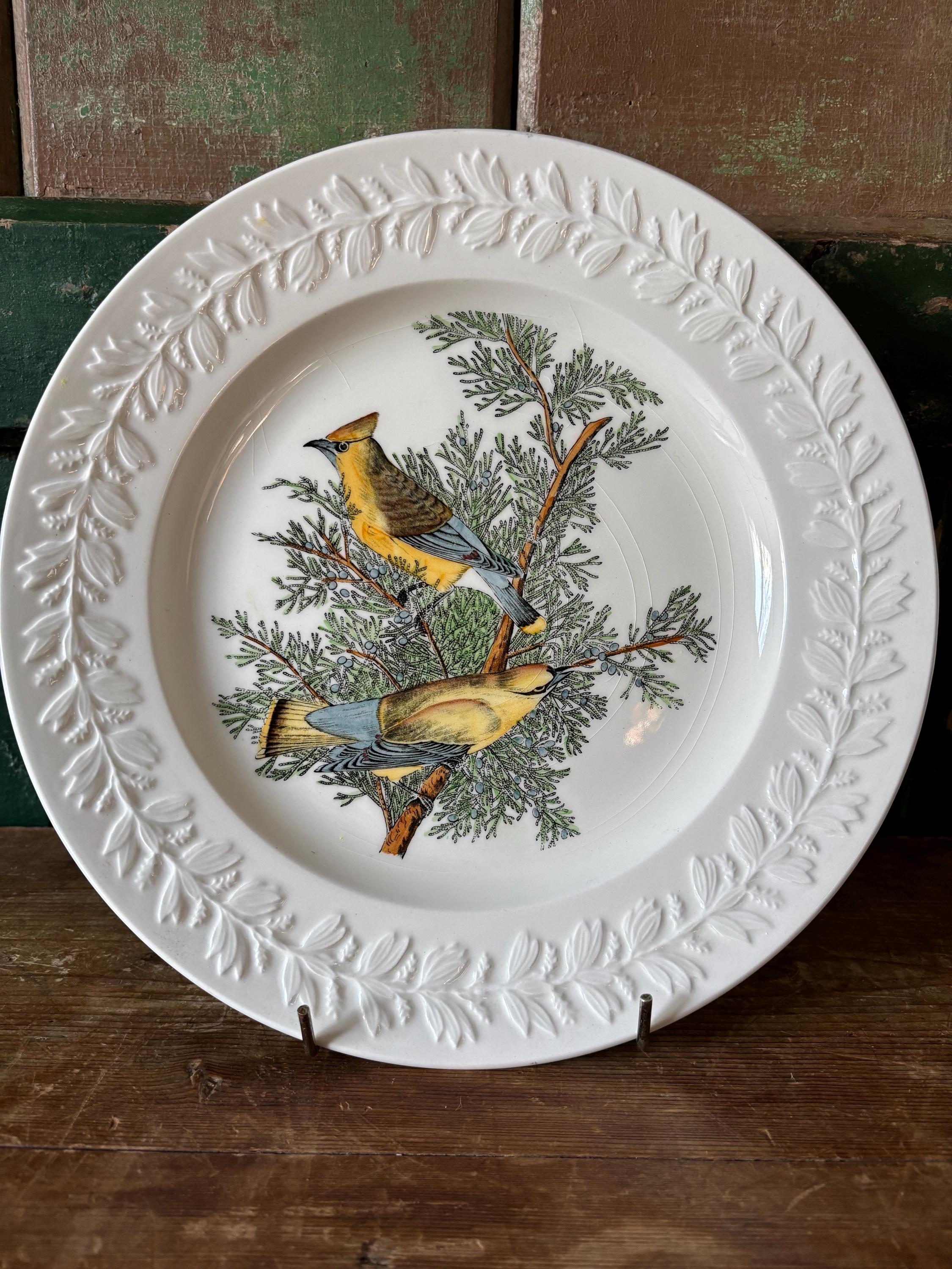 Decorative plate with bird and tree design and embossed leaf decoration