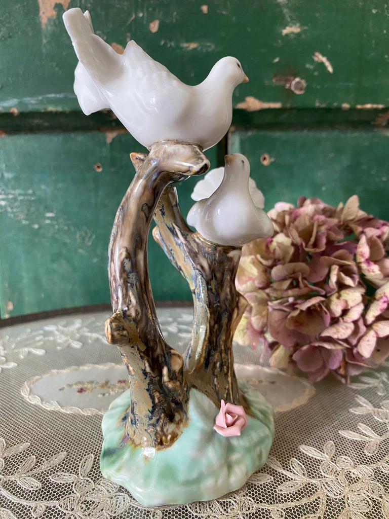 Decorative figurine with two white birds on a branch