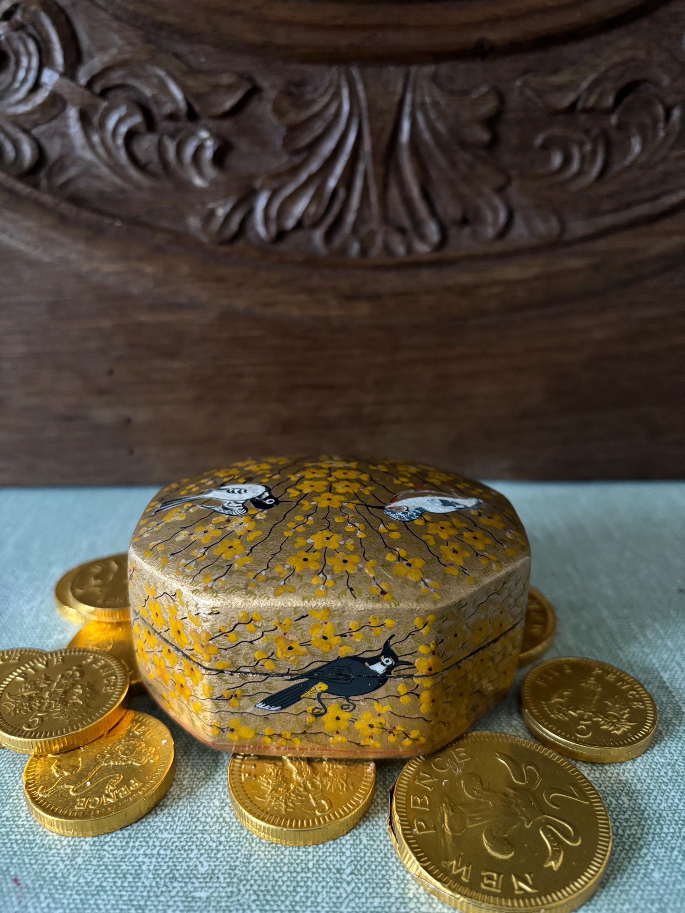 Decorative box with floral design and bird illustration.