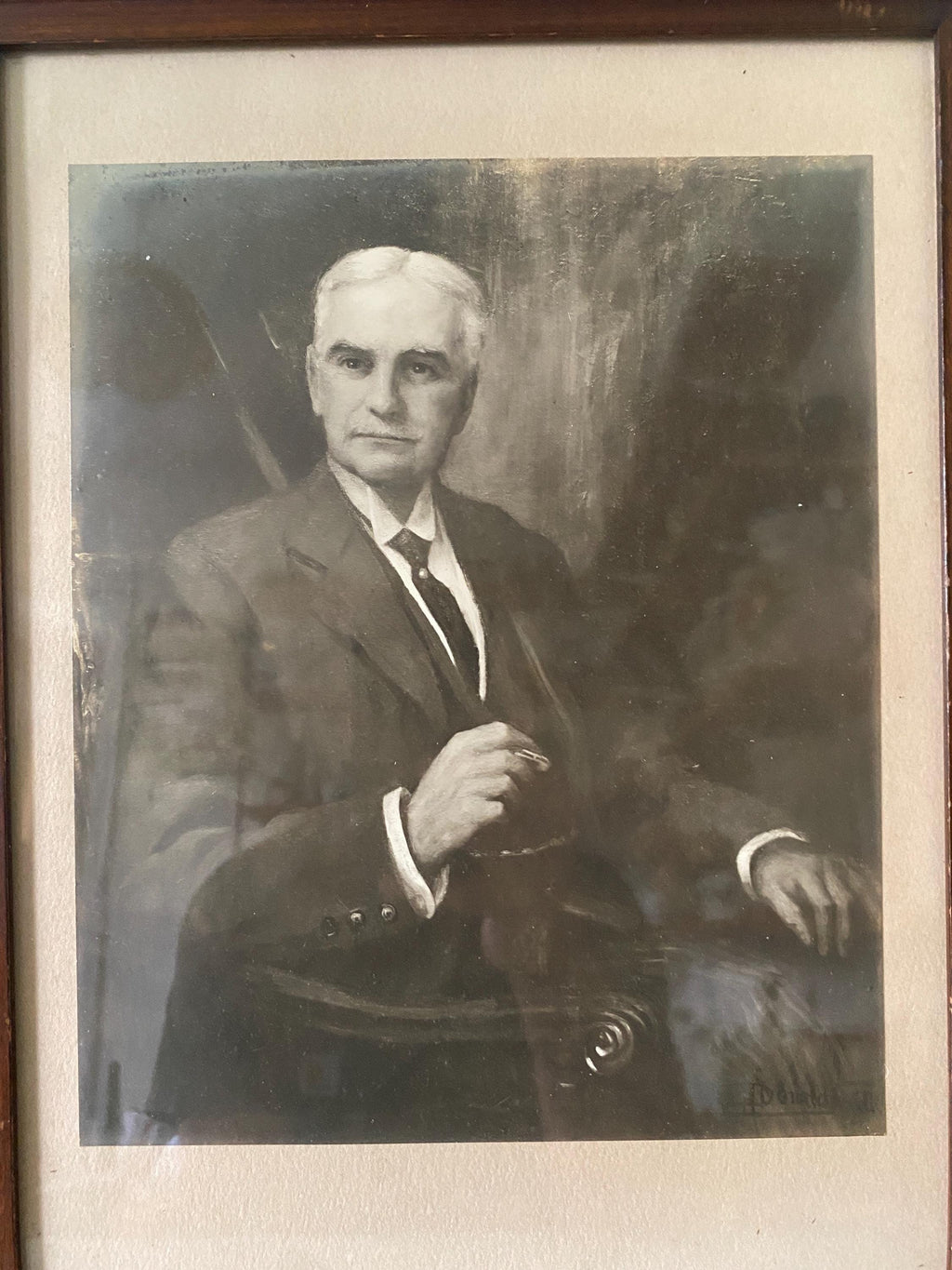 Vintage black and white portrait of a man in formal attire with a blurred background