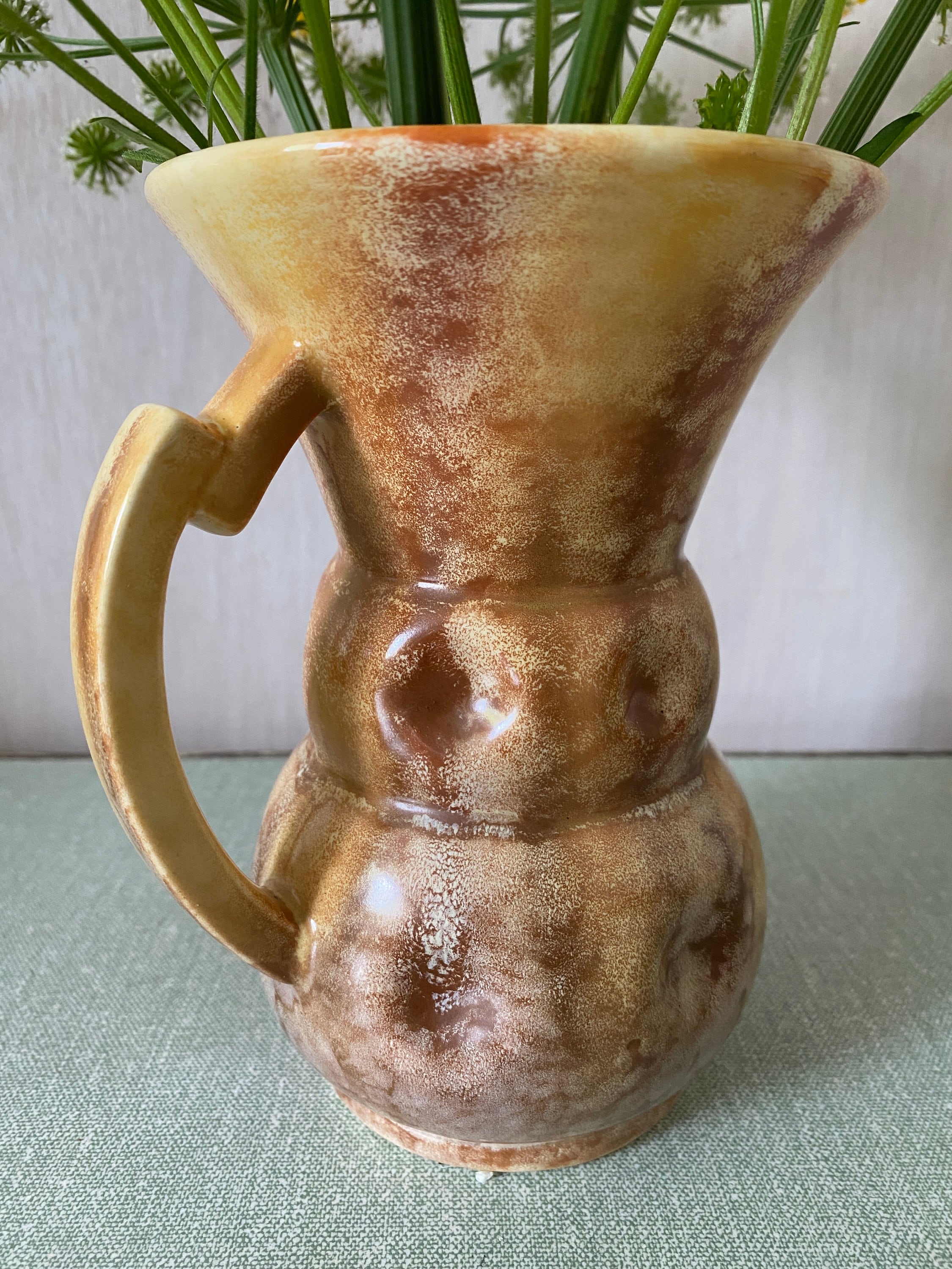 Brown ceramic jug with mottled glaze