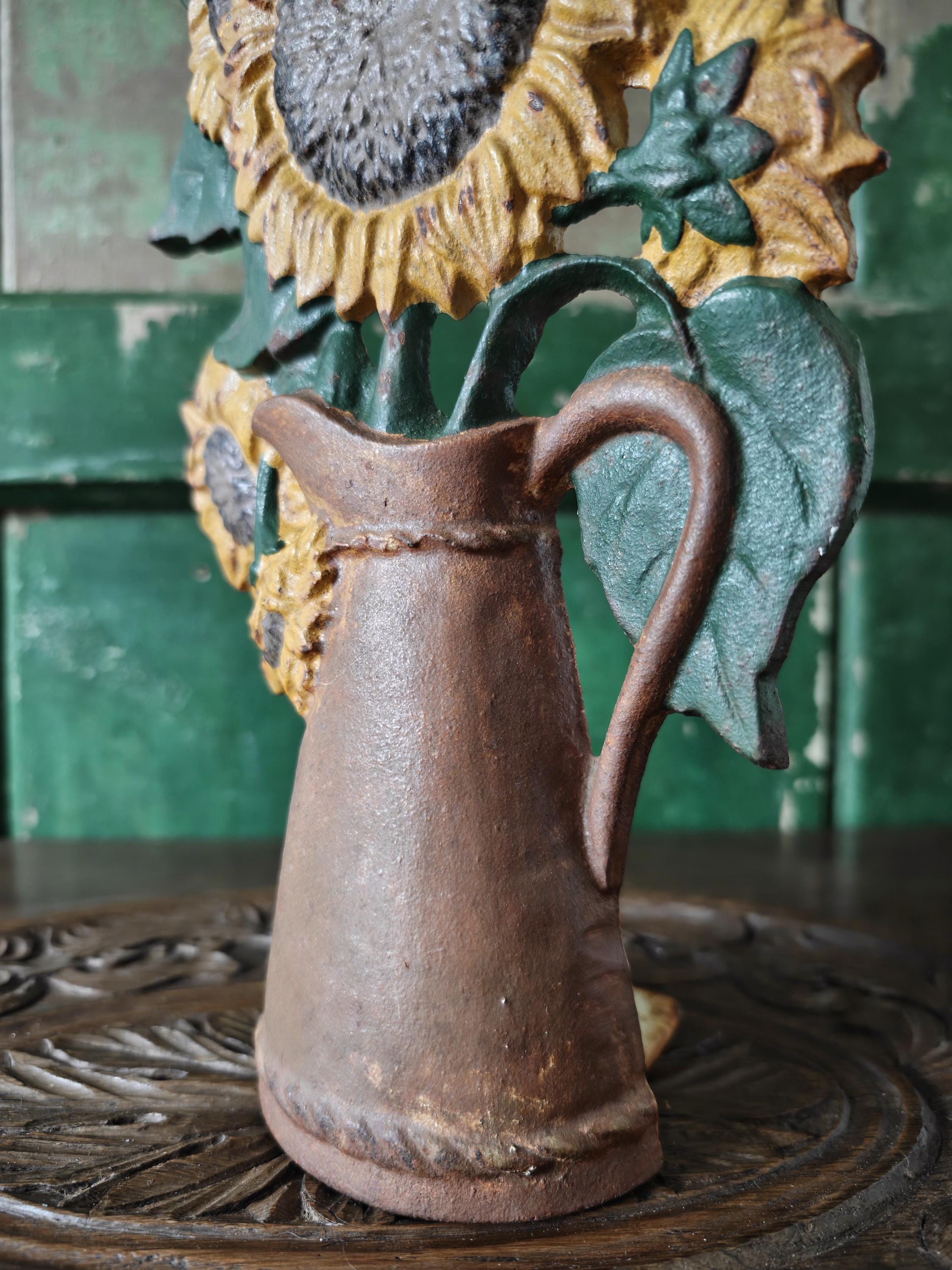 Decorative pitcher with sunflower design on a wooden surface