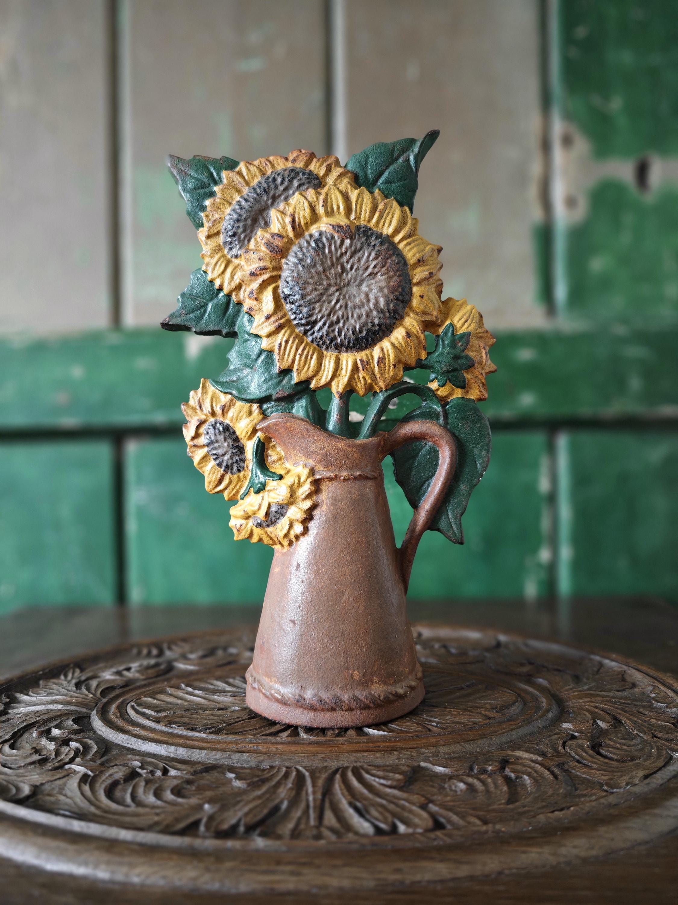 Cast iron doorstop with sunflowers in  jug