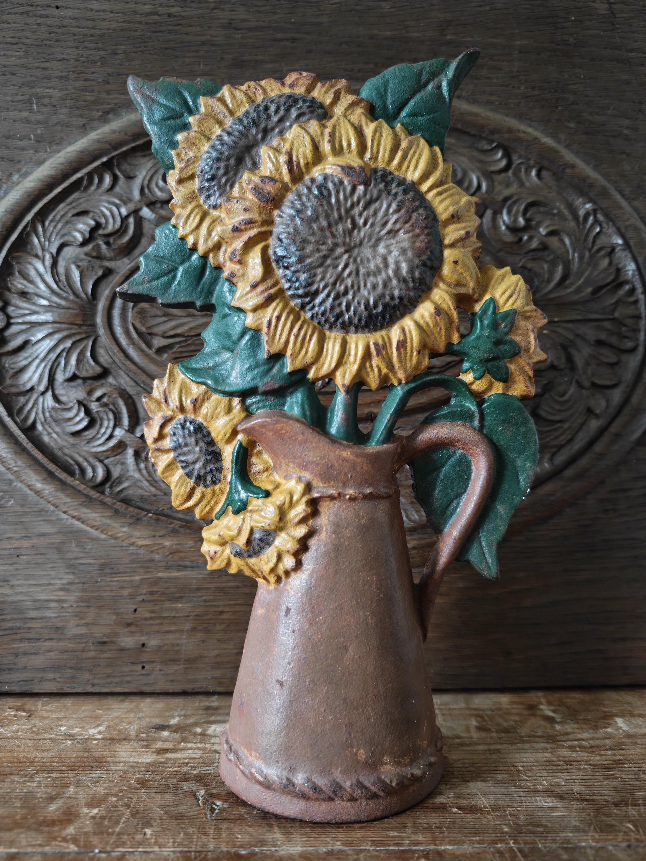 Decorative sunflower sculpture in a brown vase