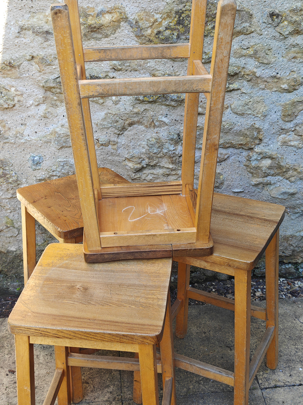 A group of rustic wooden lab stools