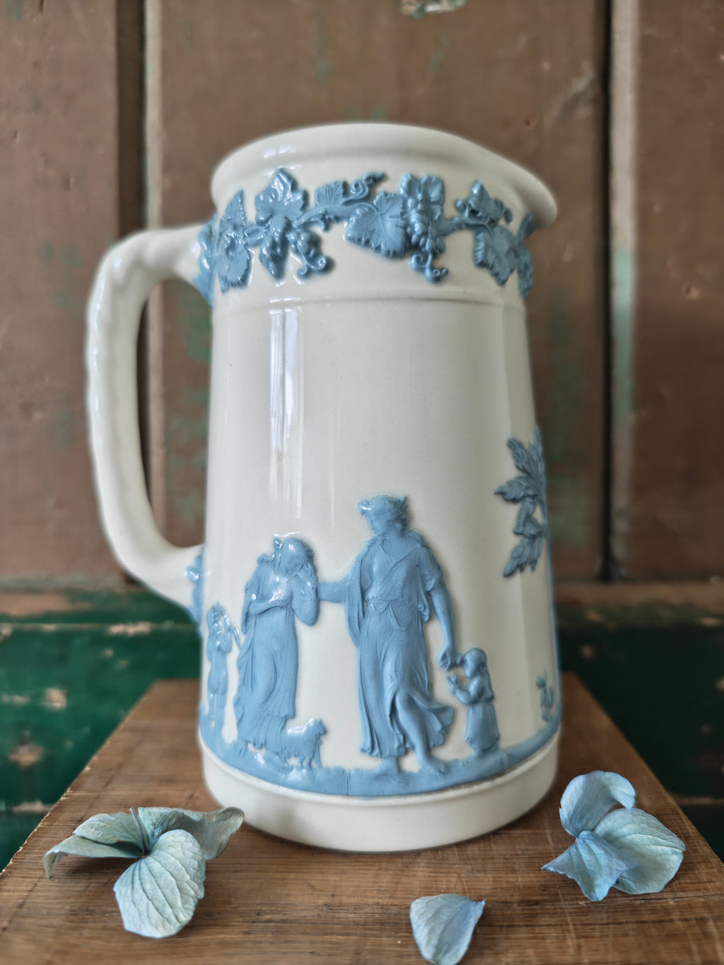Ceramic jug with embossed blue and white design