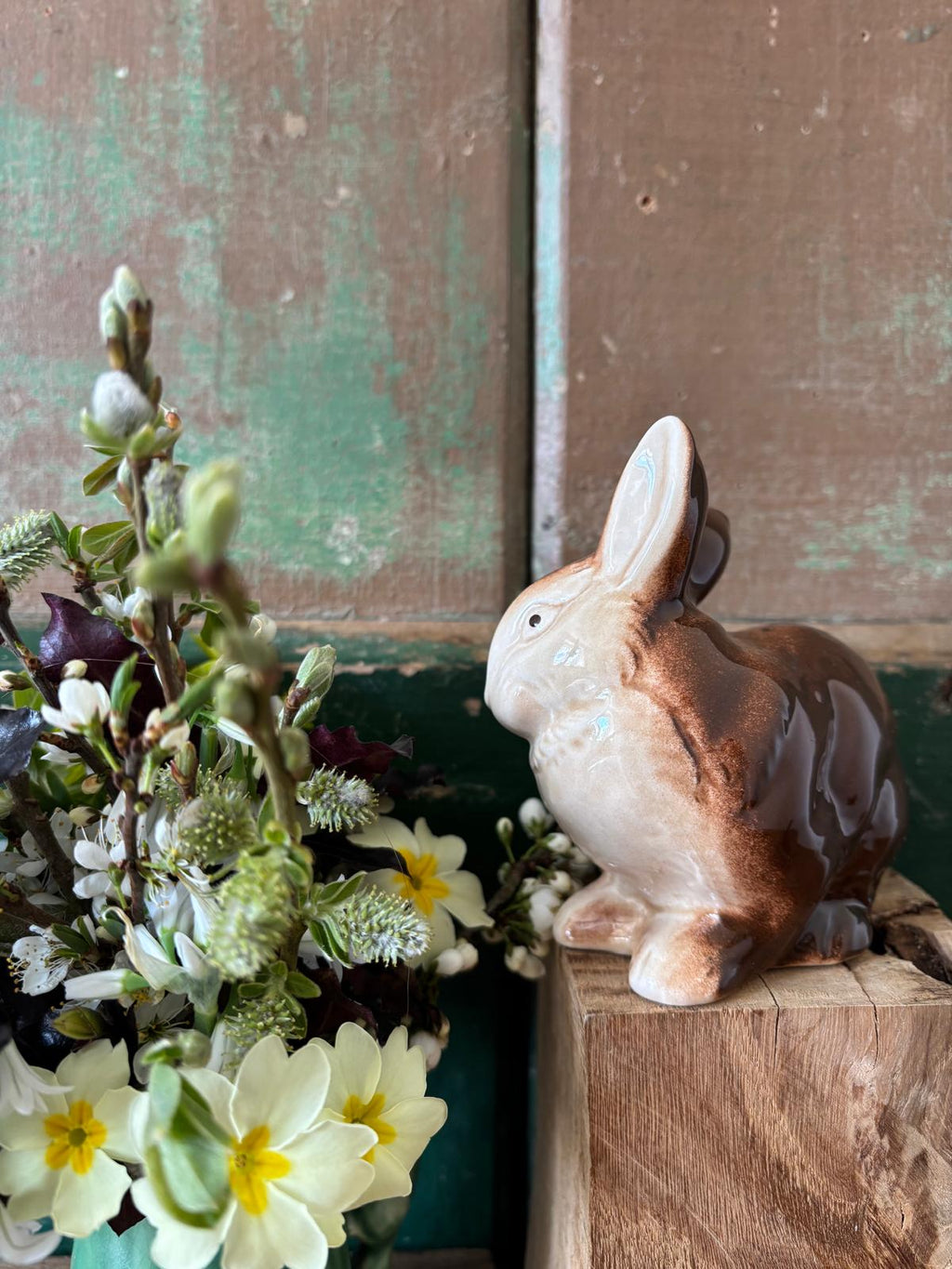 Decorative rabbit figurine with a floral arrangement