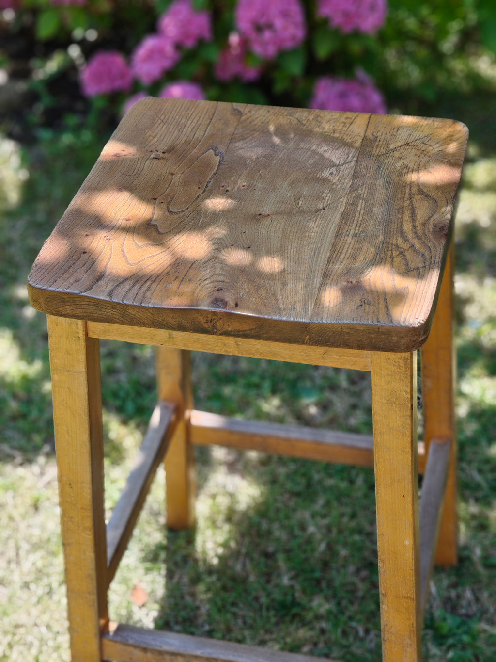A vintage wooden lab stool