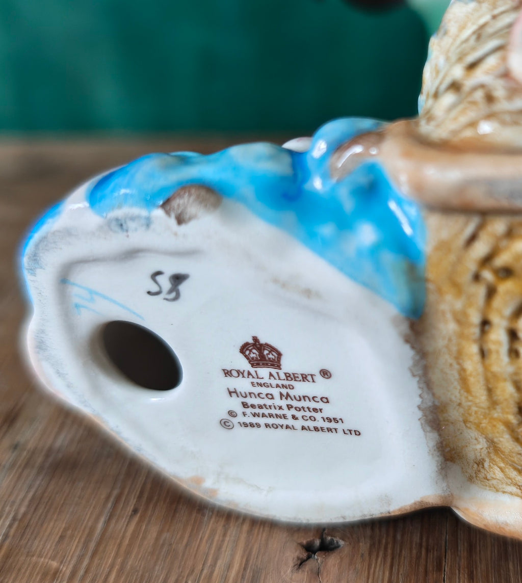 Base of a ceramic figurine with 'Royal Albert' branding.