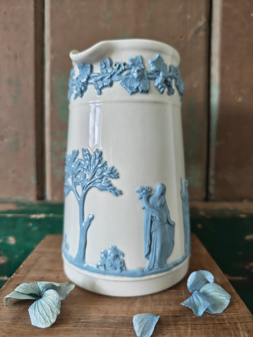 Ceramic jug with embossed blue and white design