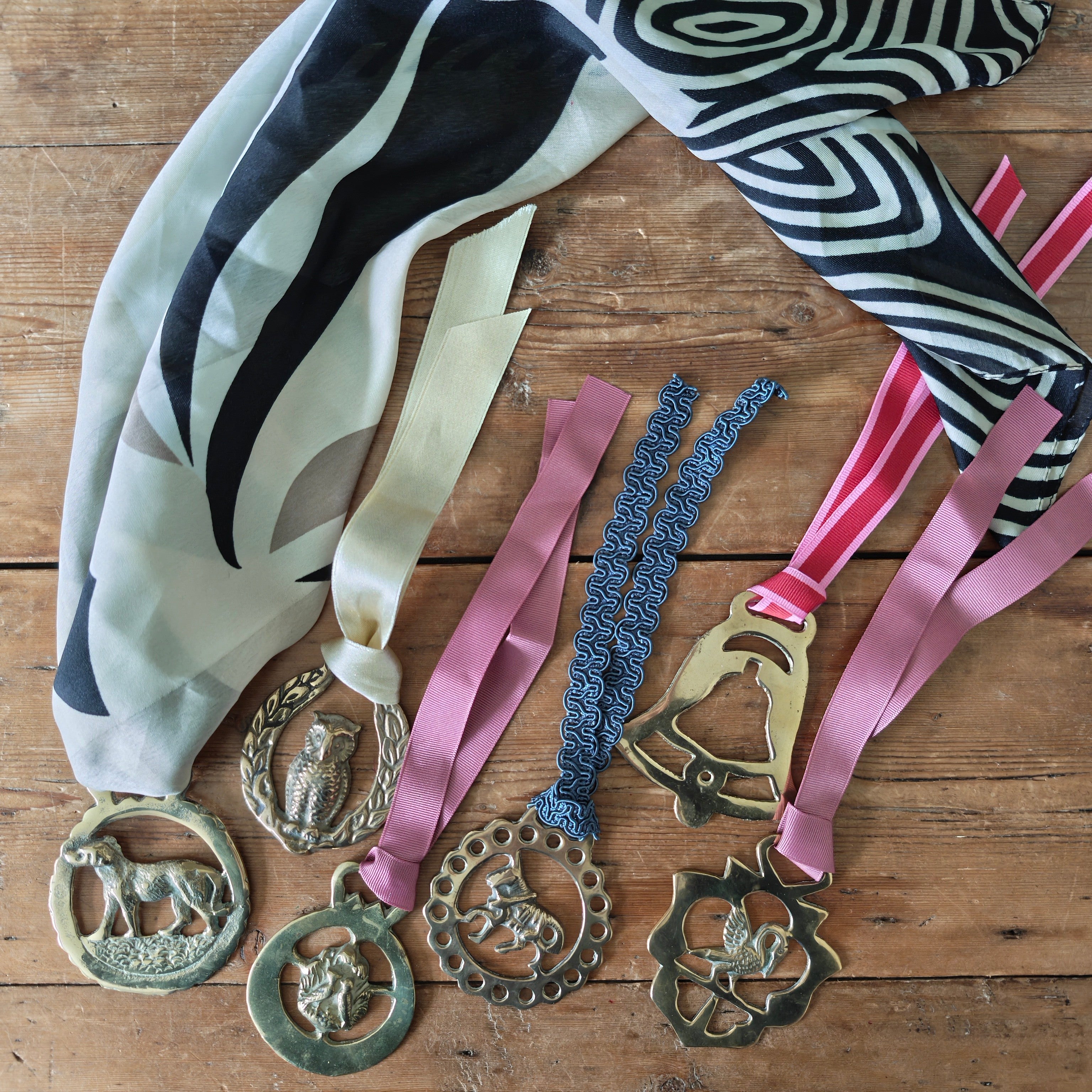 collection of decorative horse brasses with ribbons
