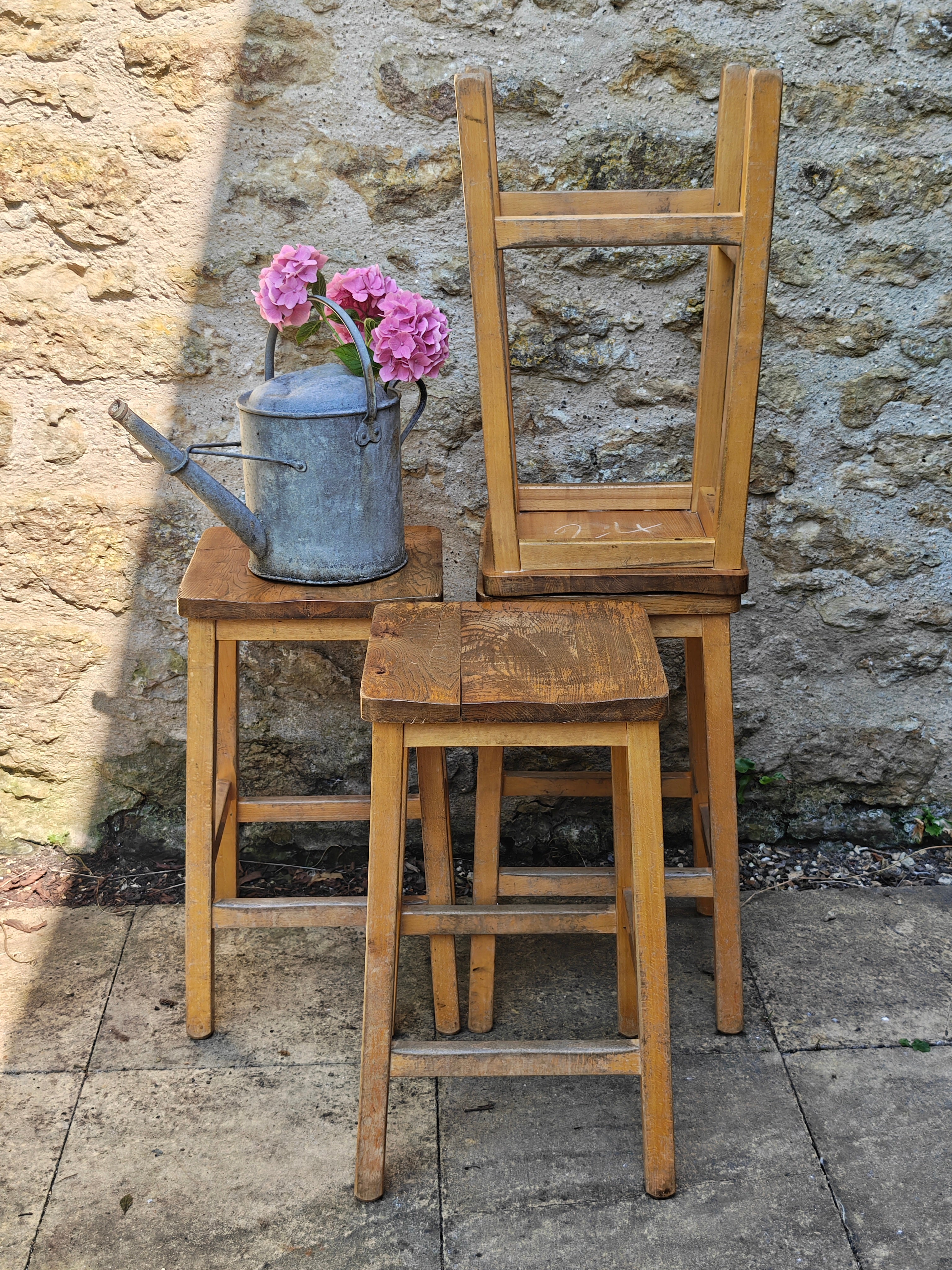 A group of rustic wooden lab stools