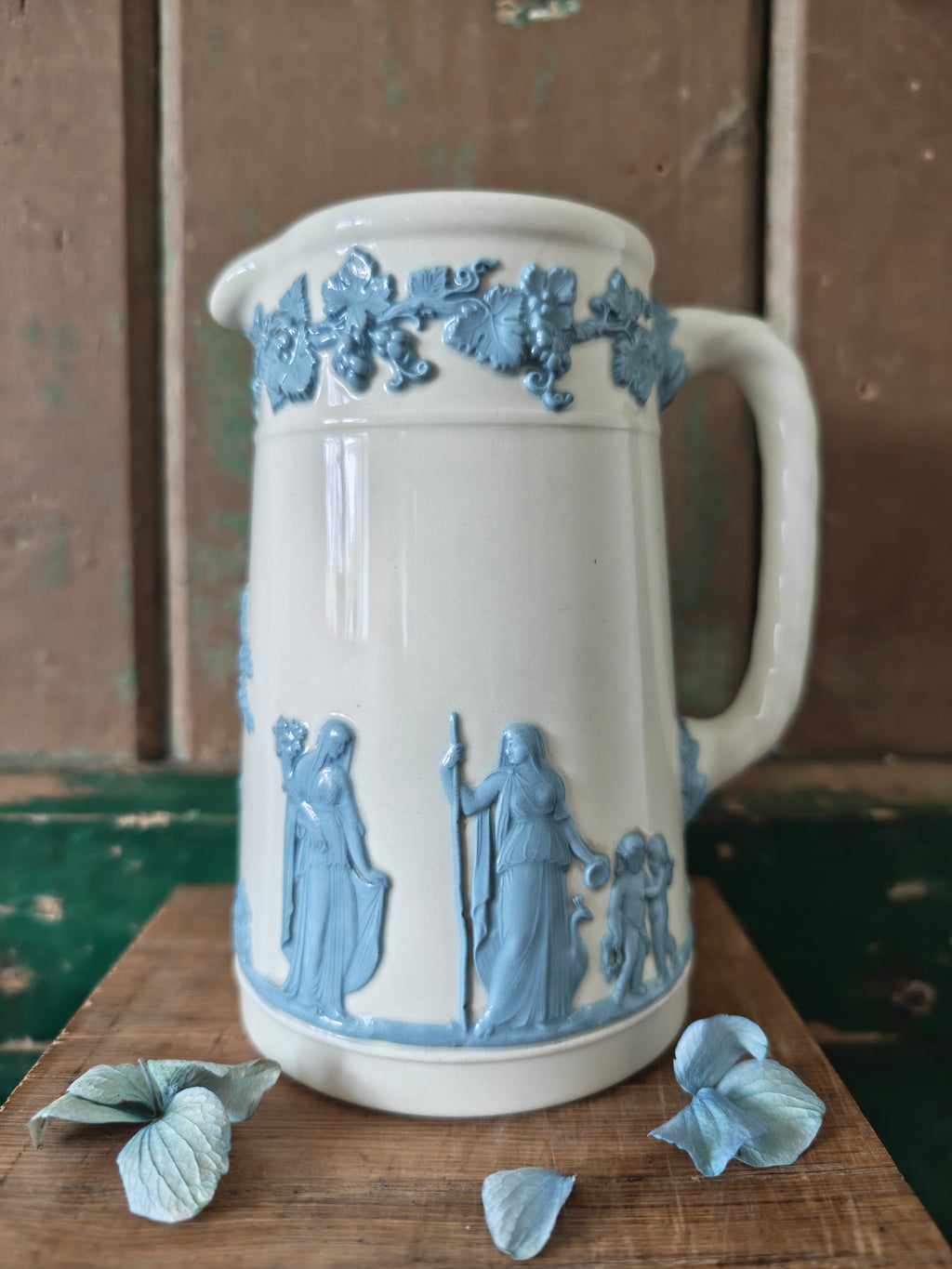 Ceramic jug with embossed blue and white design