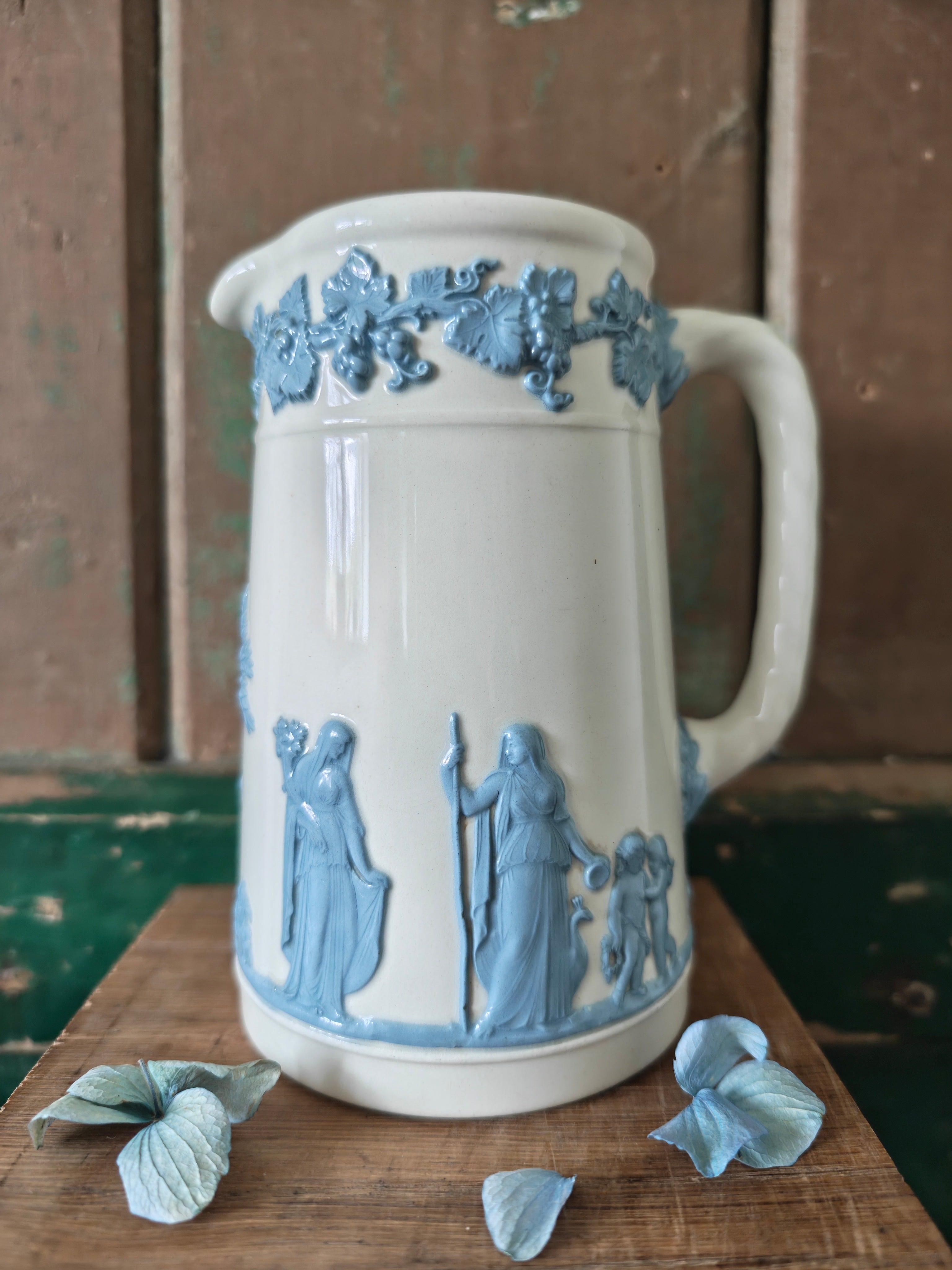 Ceramic jug with embossed blue and white design