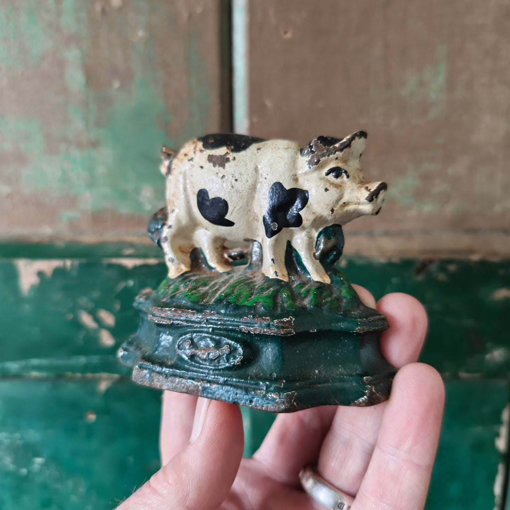 Small cast iron pig door stopper 