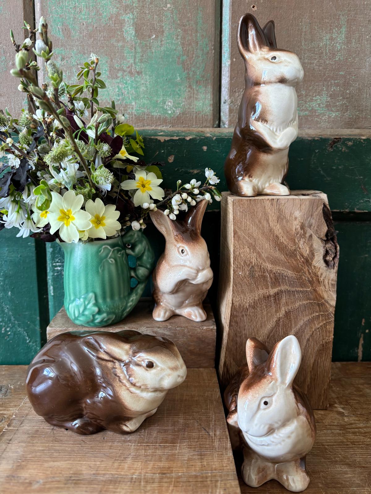 Four decorative rabbits and a vase with flowers 
