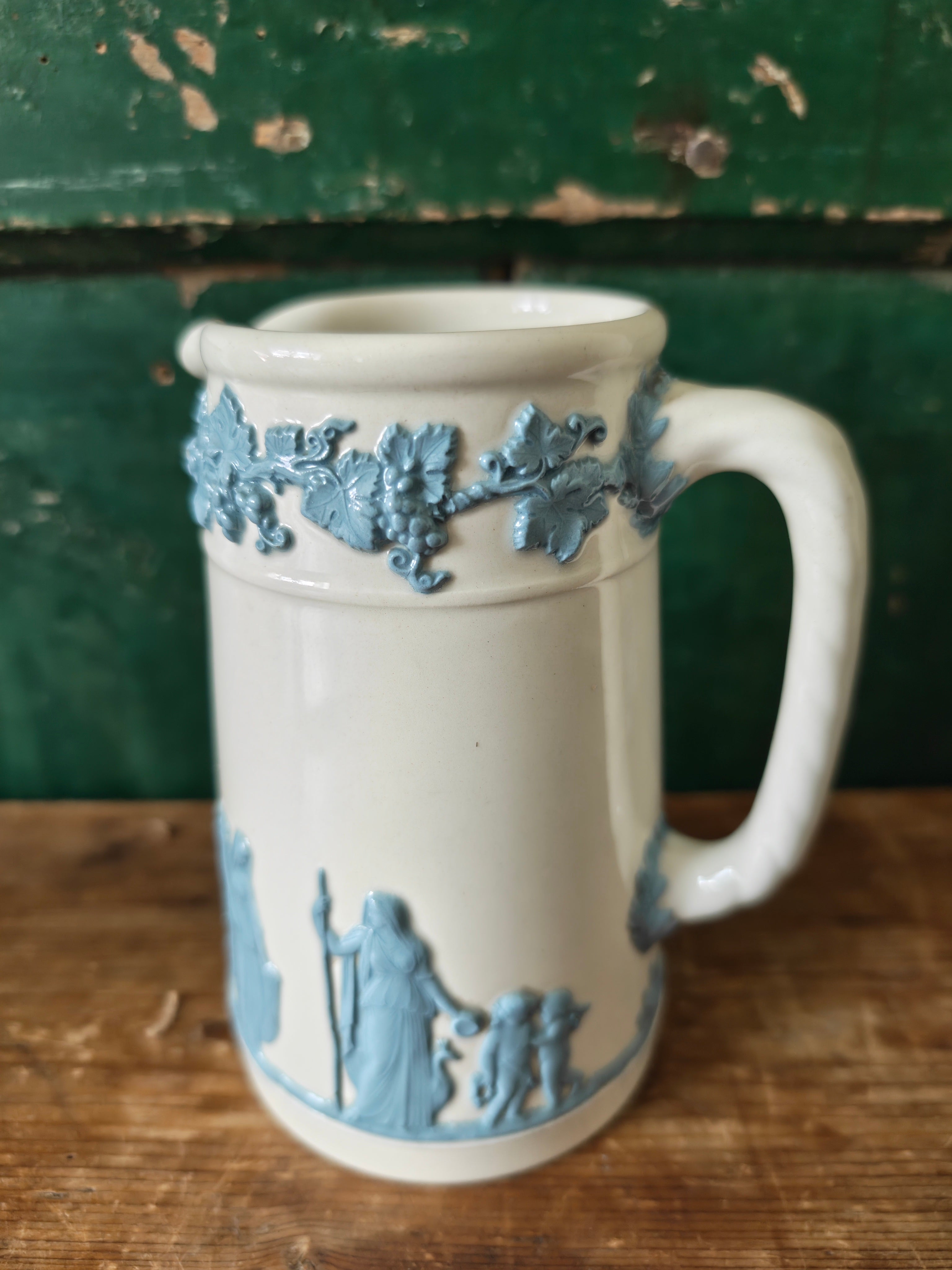 Ceramic jug with embossed blue and white design